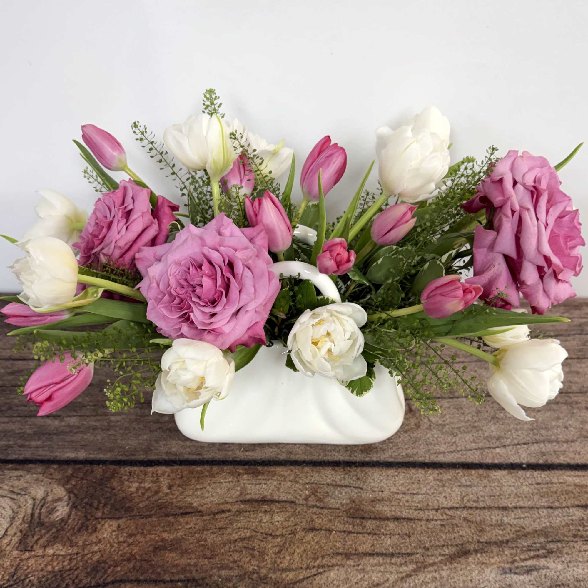Cute ceramic purse holds Spring's beautiful tulips. Approx. 10"h x 12" w.