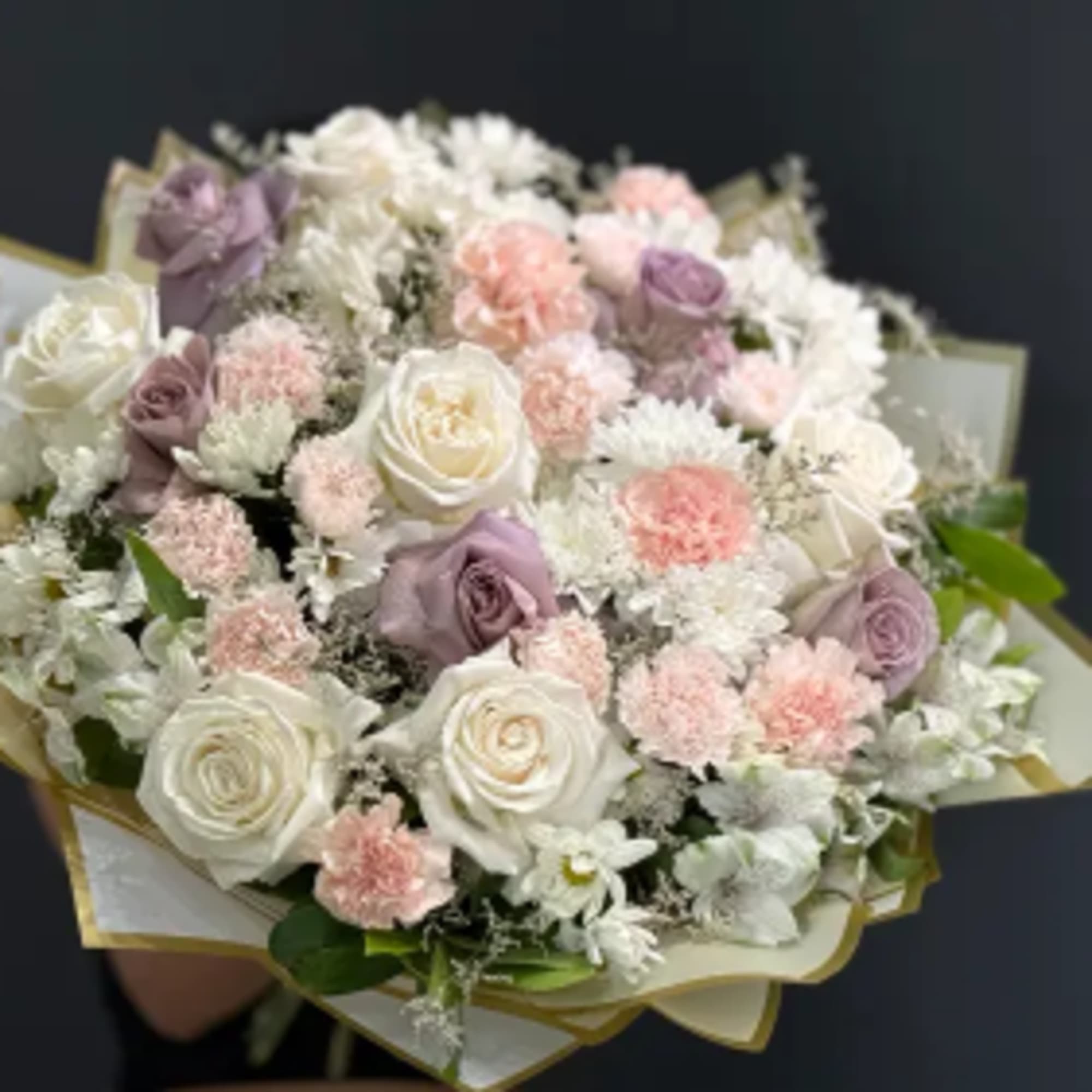Whispering Blooms Bouquet is a delicate composition designed in a soft, romantic