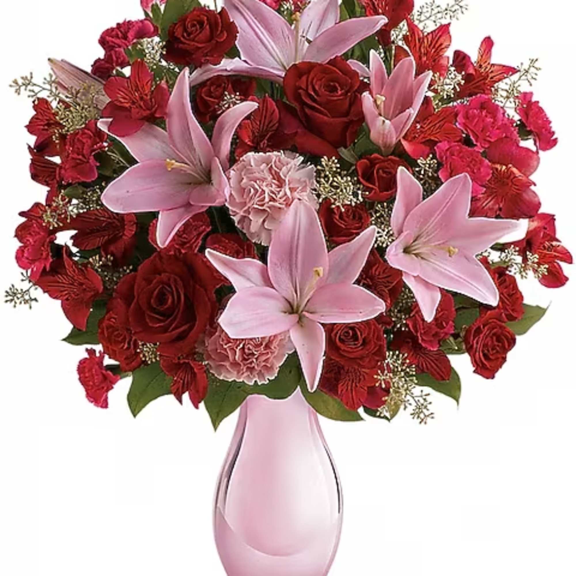 Pink lilies and red roses arranged in a pink glass vase