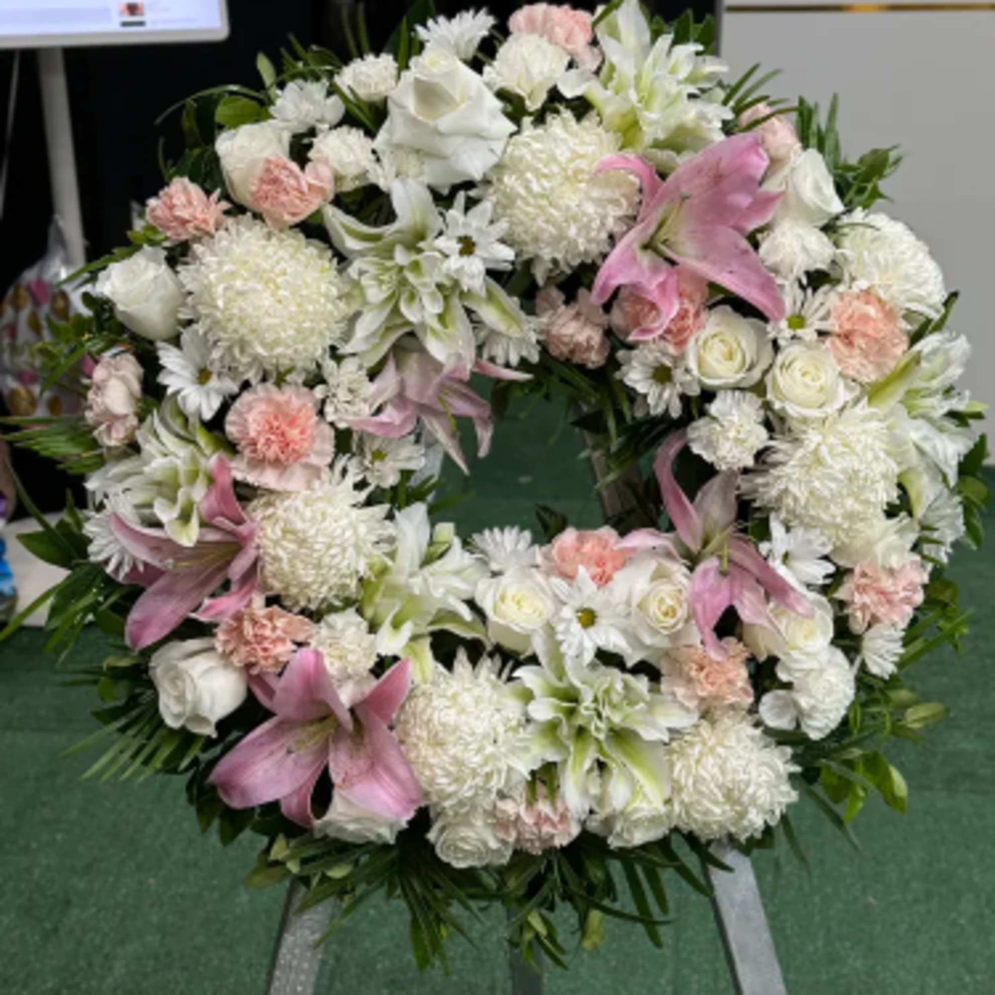 Graceful Remembrance is a refined circular sympathy arrangement designed to honor the