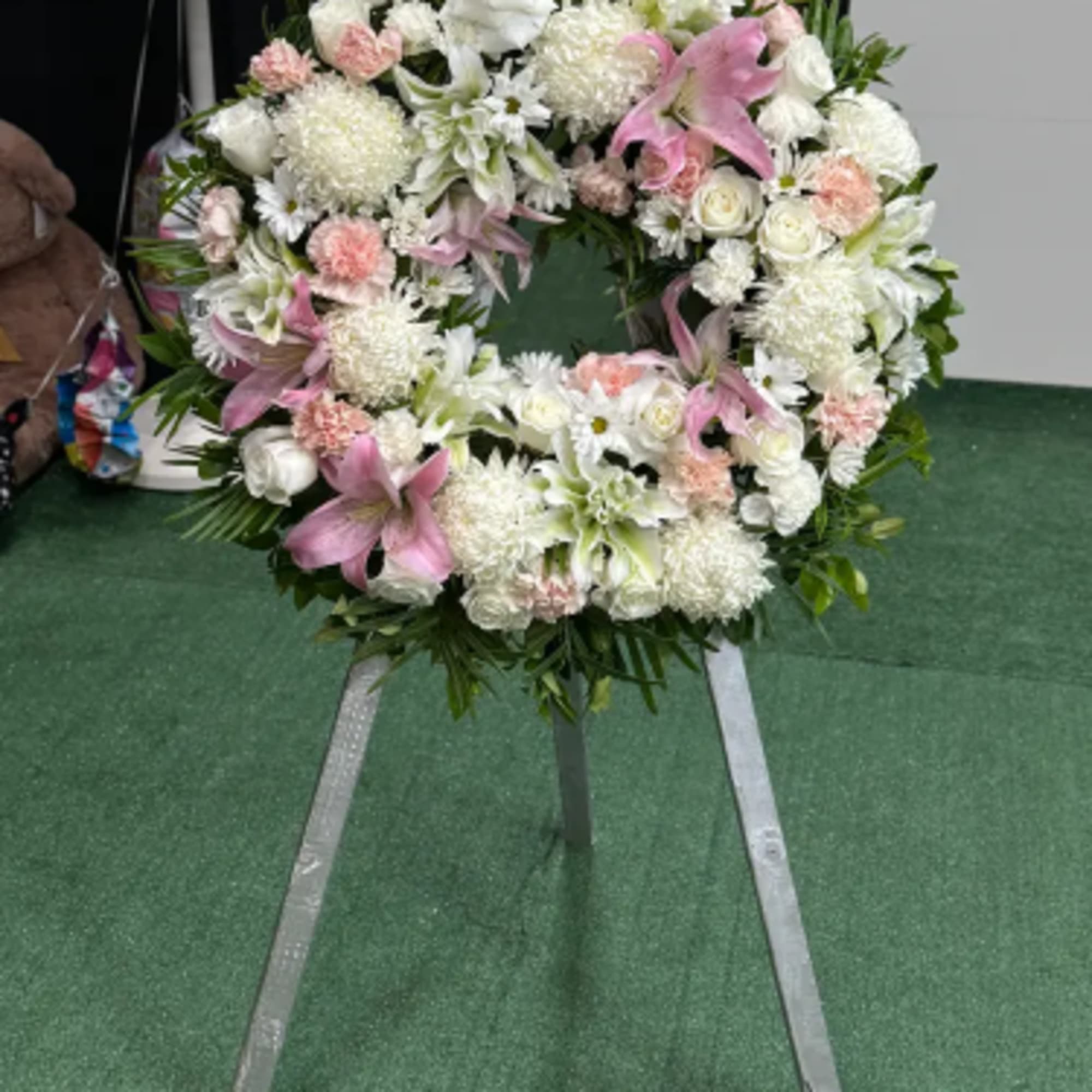 Graceful Remembrance is a refined circular sympathy arrangement designed to honor the