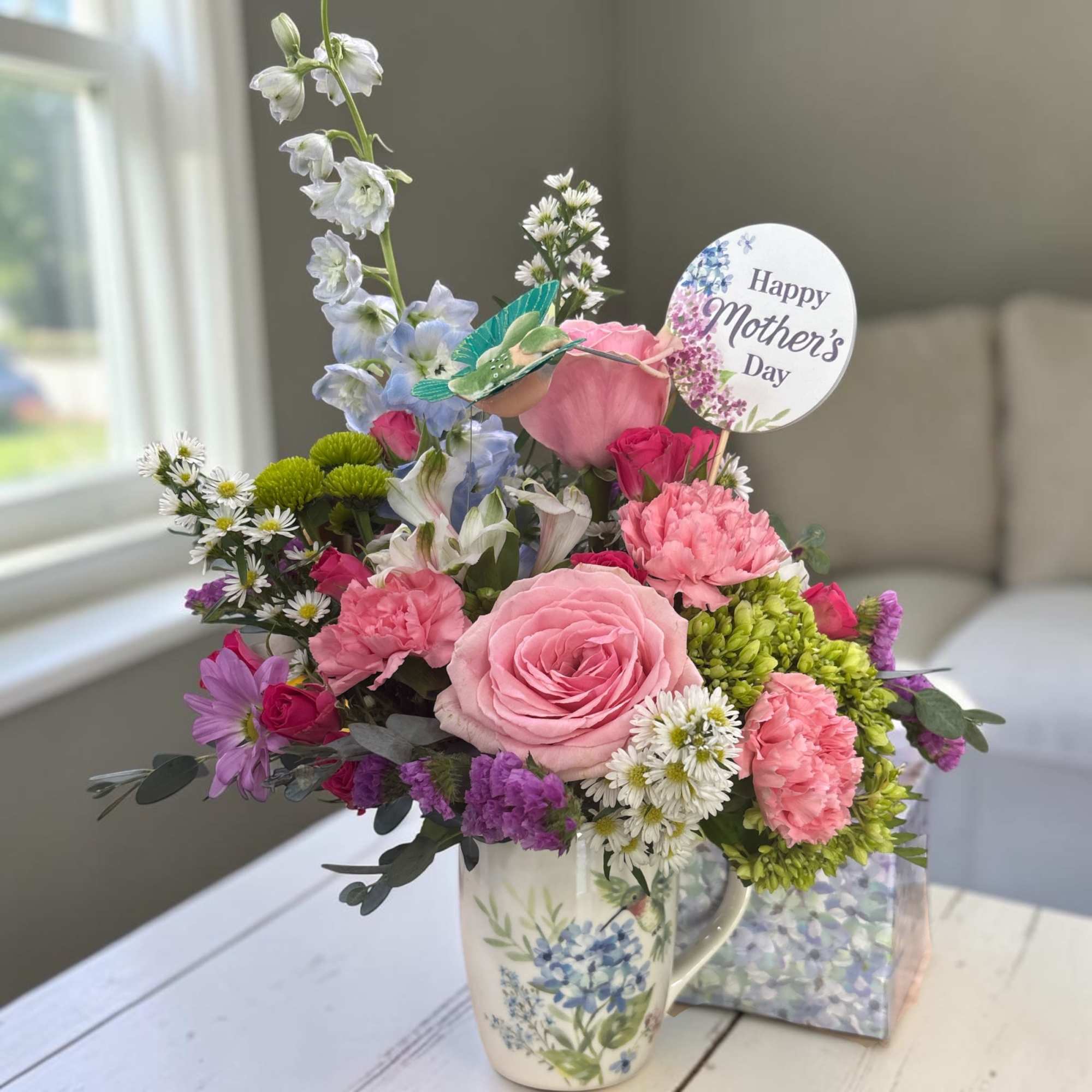 Celebrate Mom with our charming Fluttering Garden Coffee Mug, a fresh flower