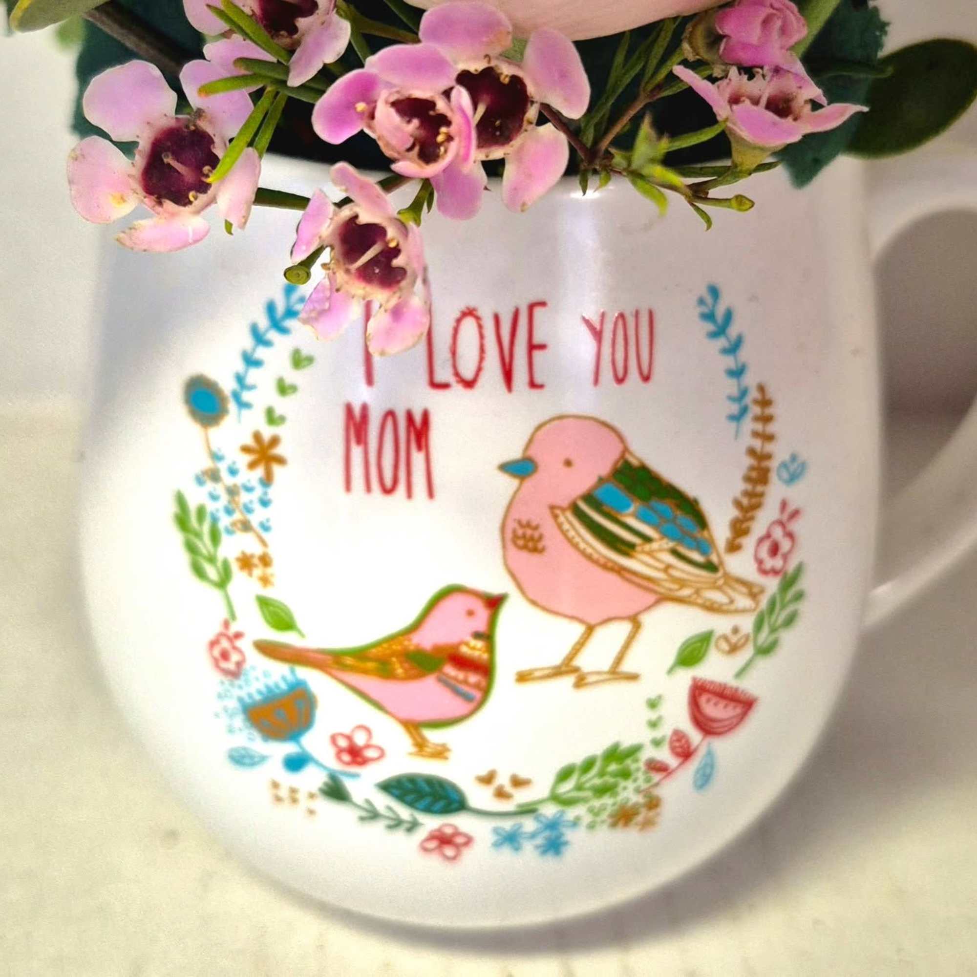 A lovely sentiment in a beautiful mug filled with flowers. Add a
