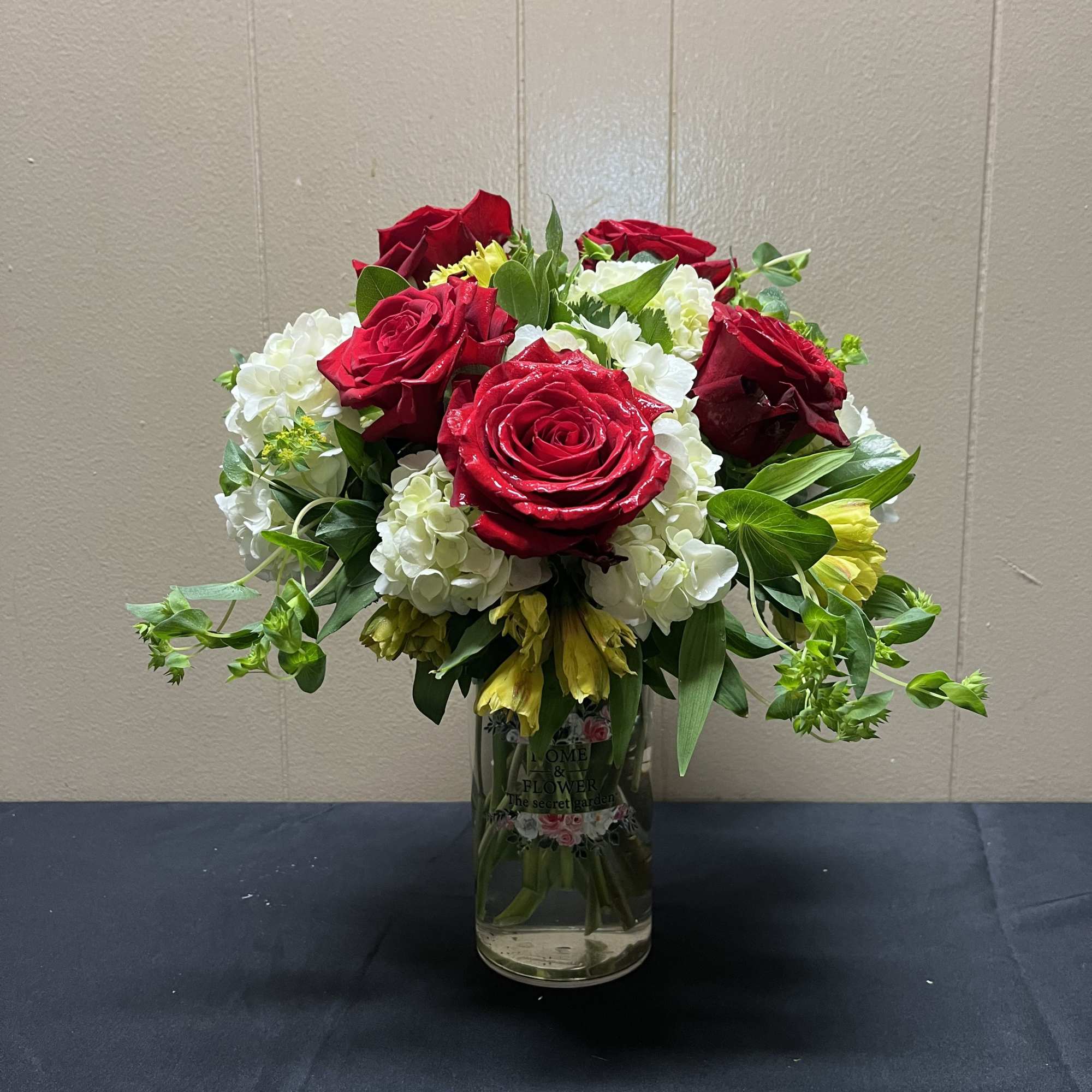 A cluster of rich red roses arranged above a cloud of white