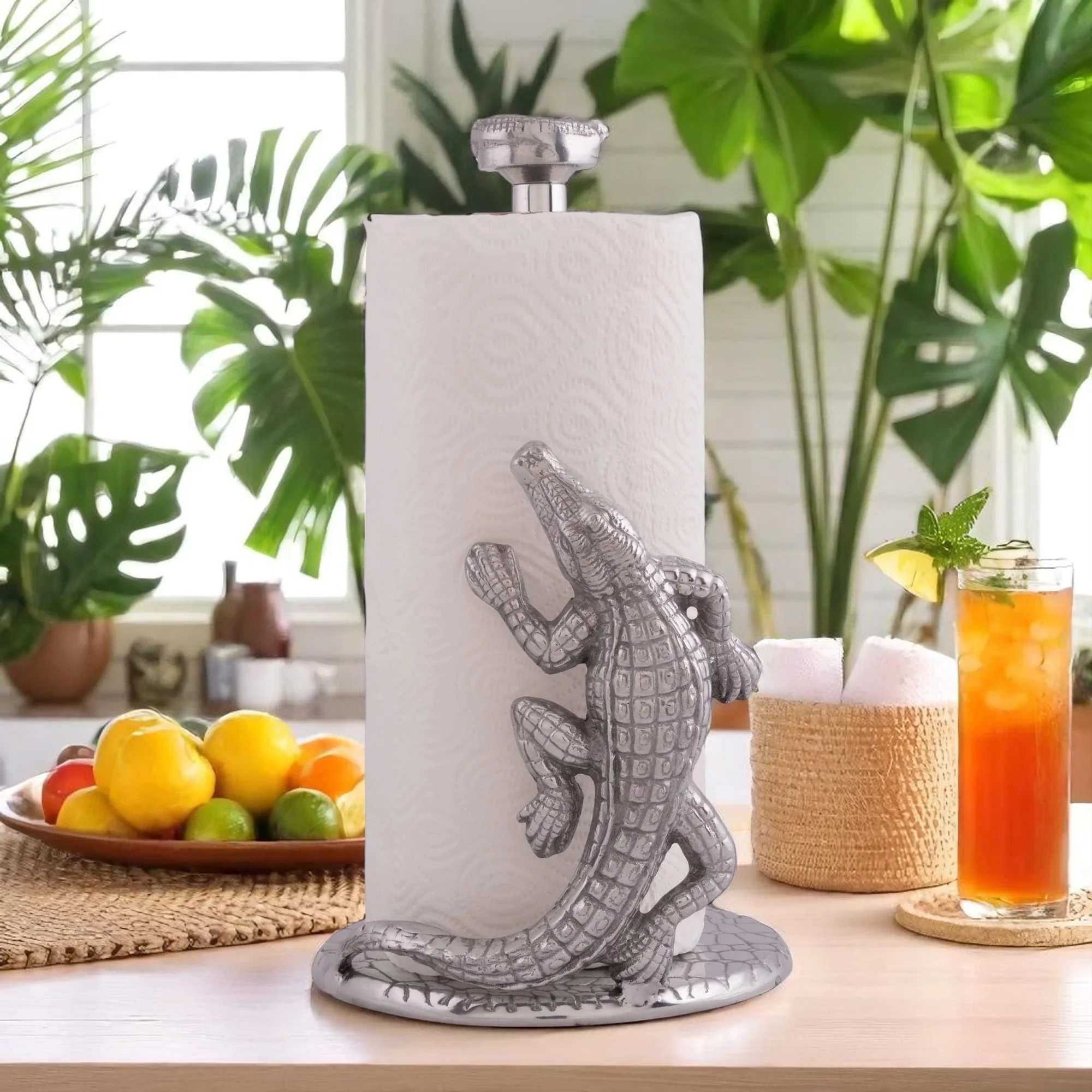 A sculptural silver alligator wraps playfully around a tall white paper towel