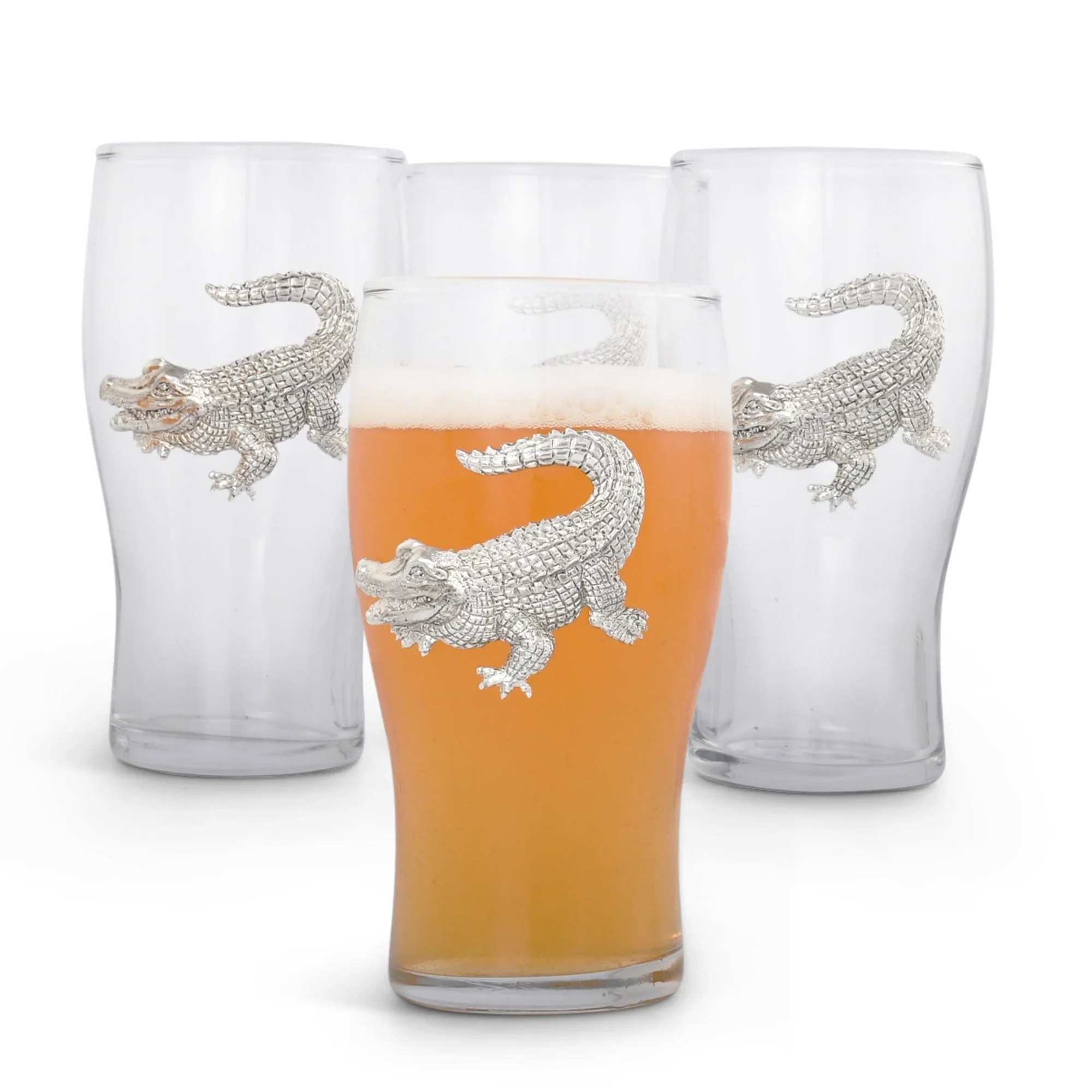 Four clear drinking glasses with silver alligator designs