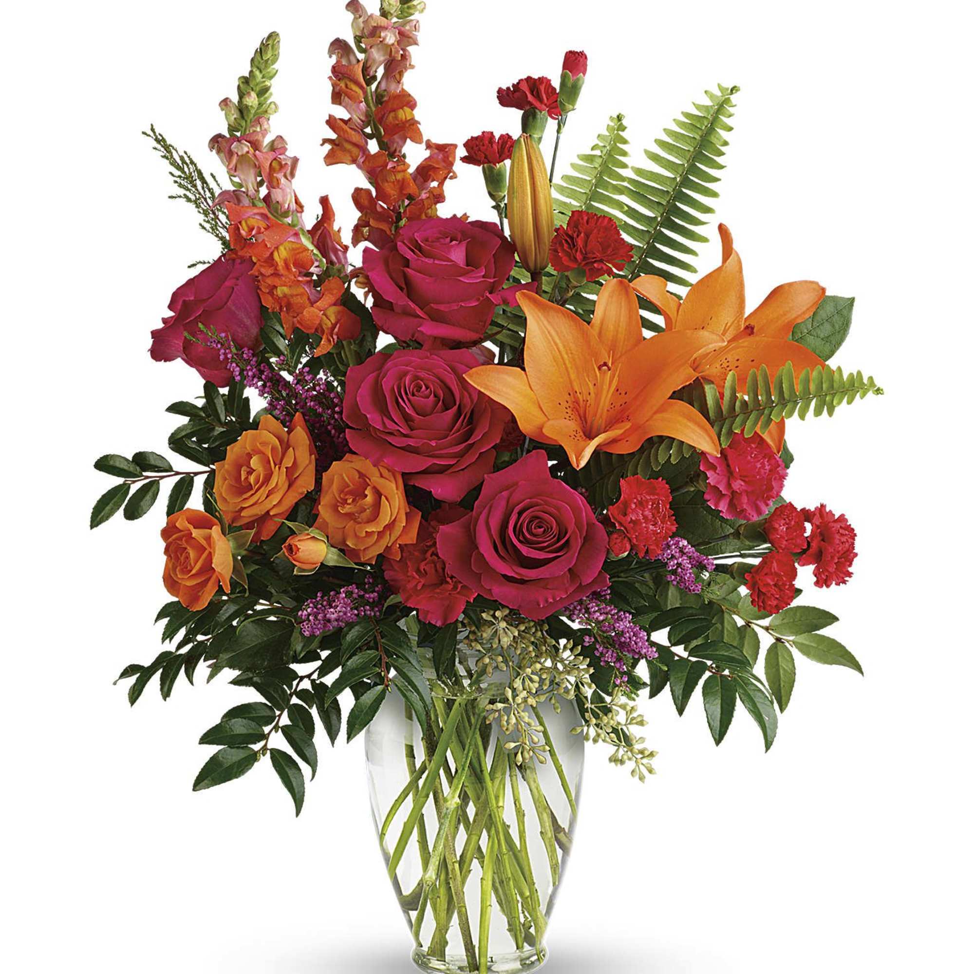 Bouquet of orange lilies and pink roses in a clear glass vase