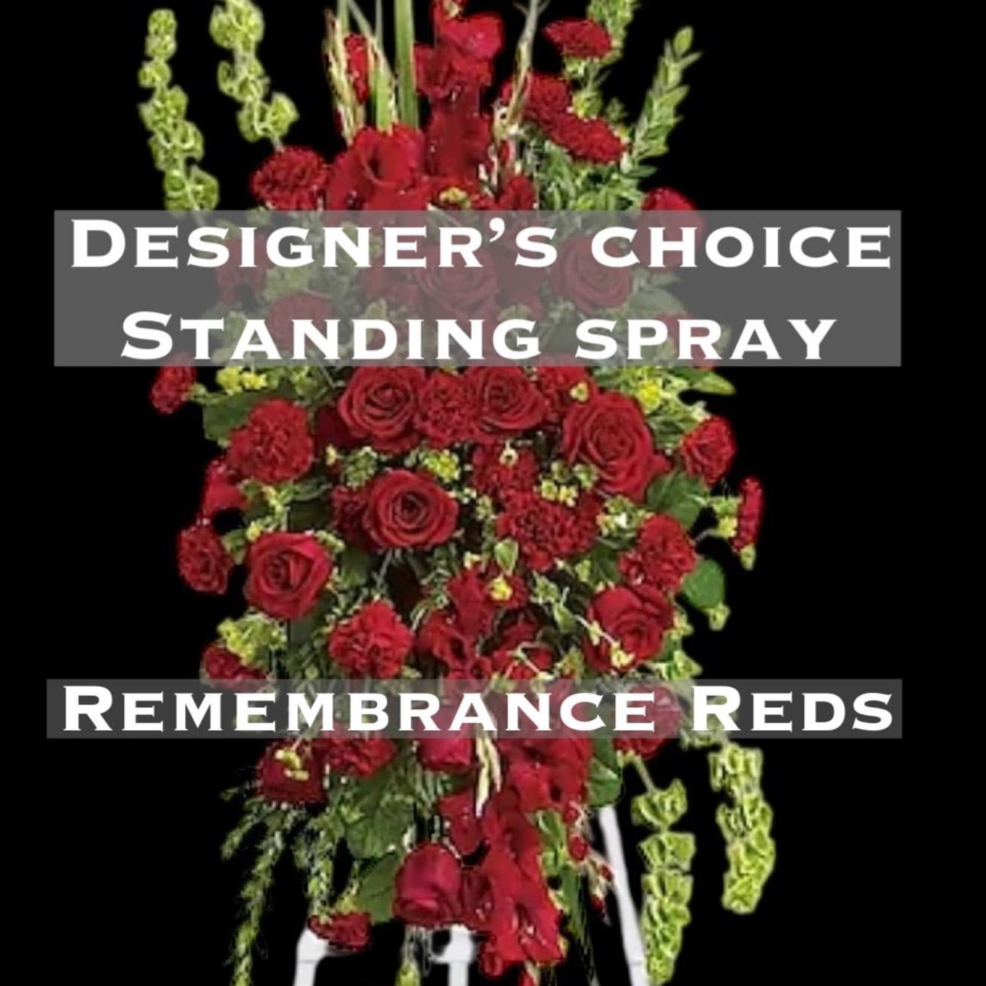 Red standing spray with roses and carnations on a white easel