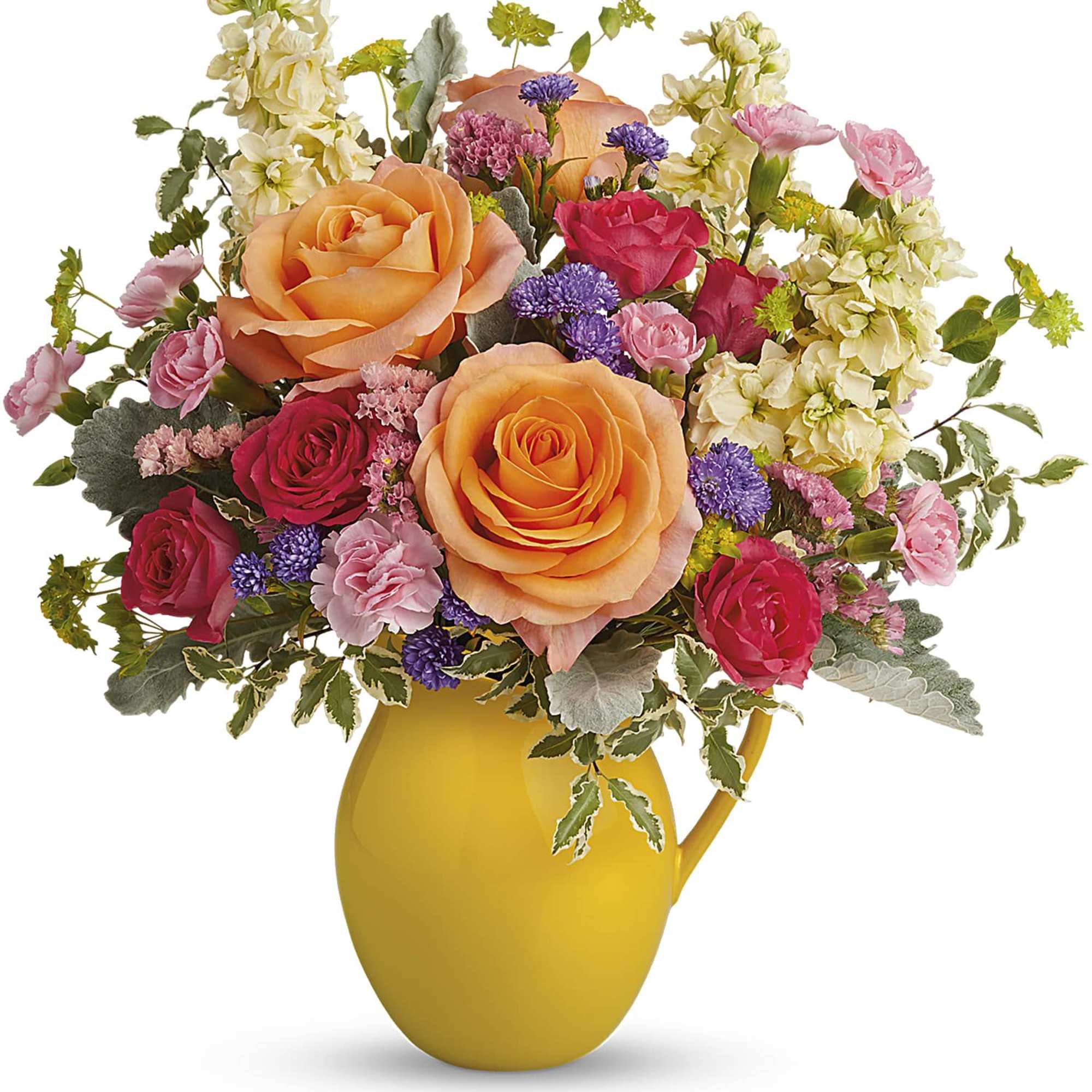 Mixed bouquet of roses and small flowers in a yellow pitcher vase