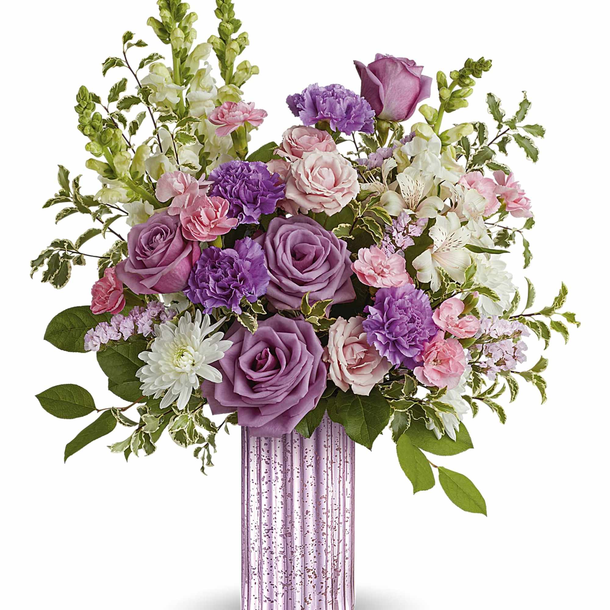 Arrangement of purple roses, pink carnations, and white blooms in a tall pink glass vase