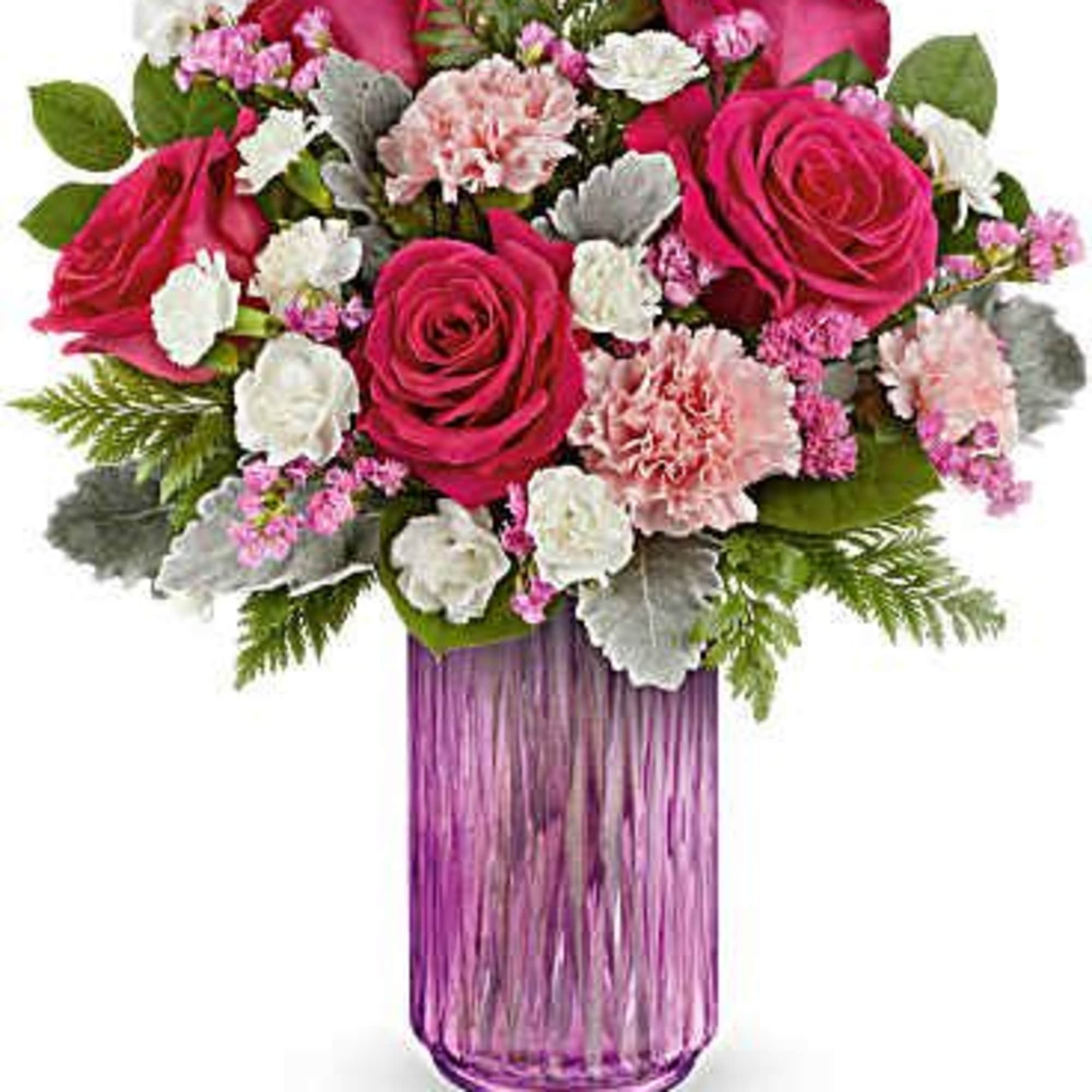 Pink roses and carnations in a purple glass vase