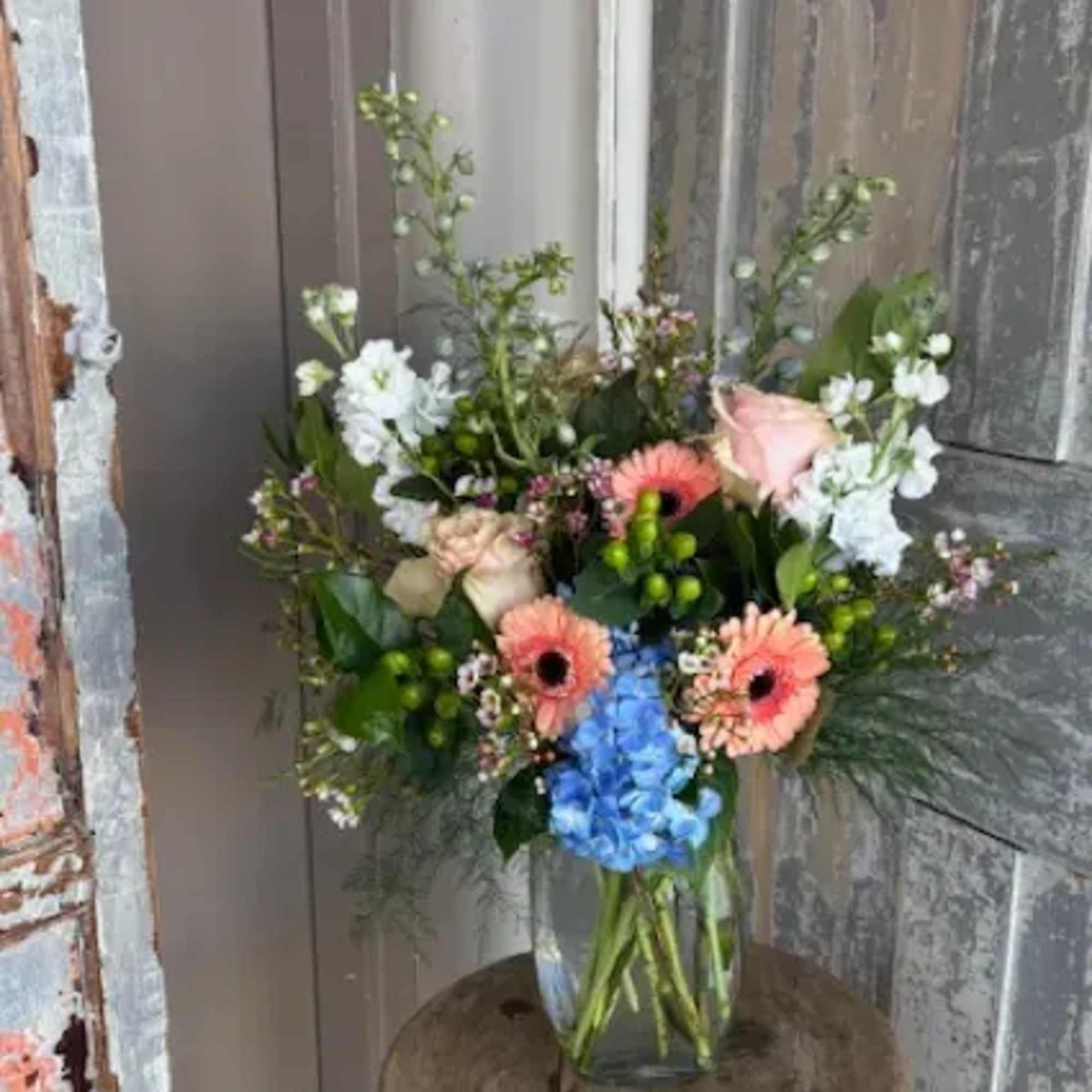 Peach Gerber, Hydrangea, Poses and several different types of greenery make for