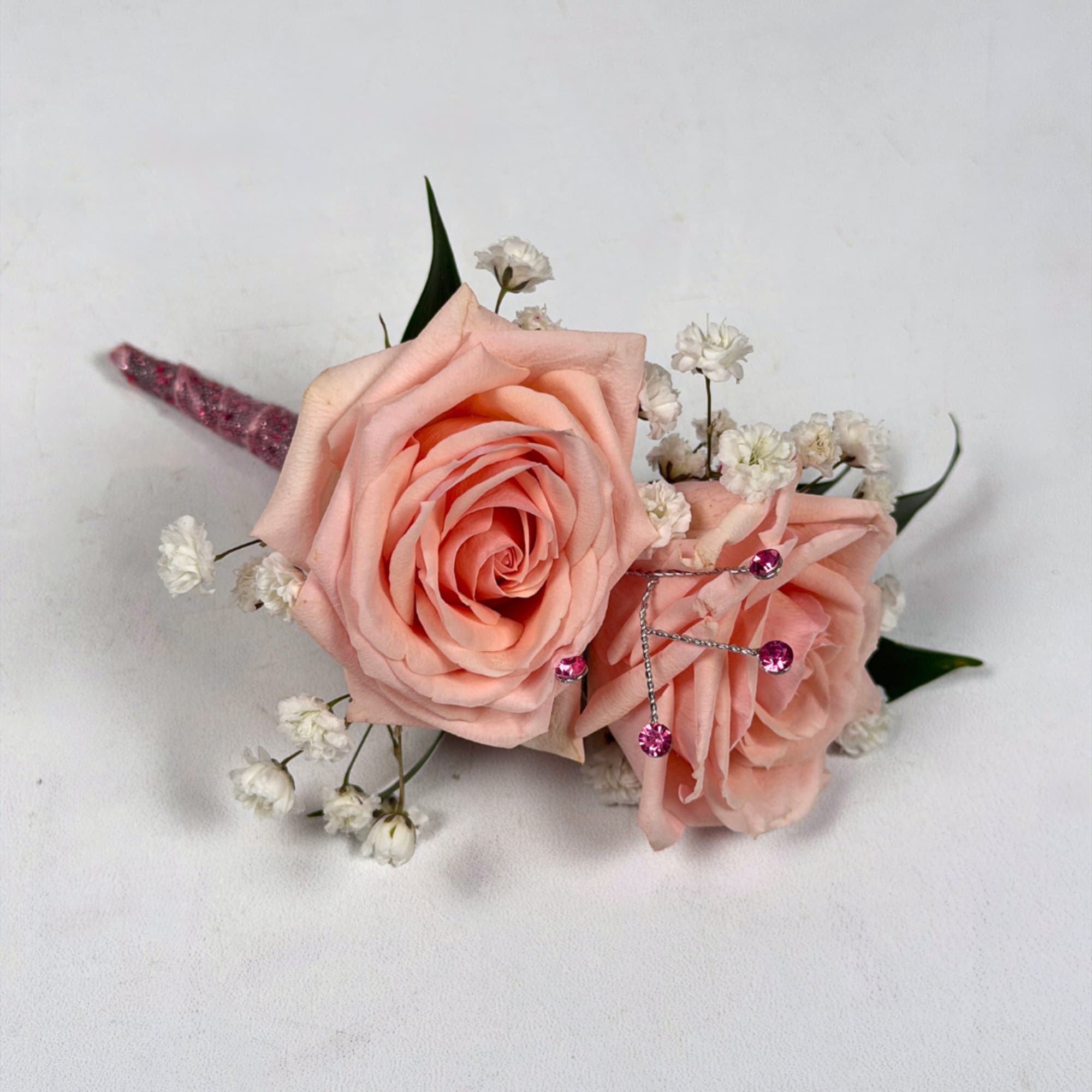 Two pale blush roses sit snugly together in this Rose Quartz boutonniere