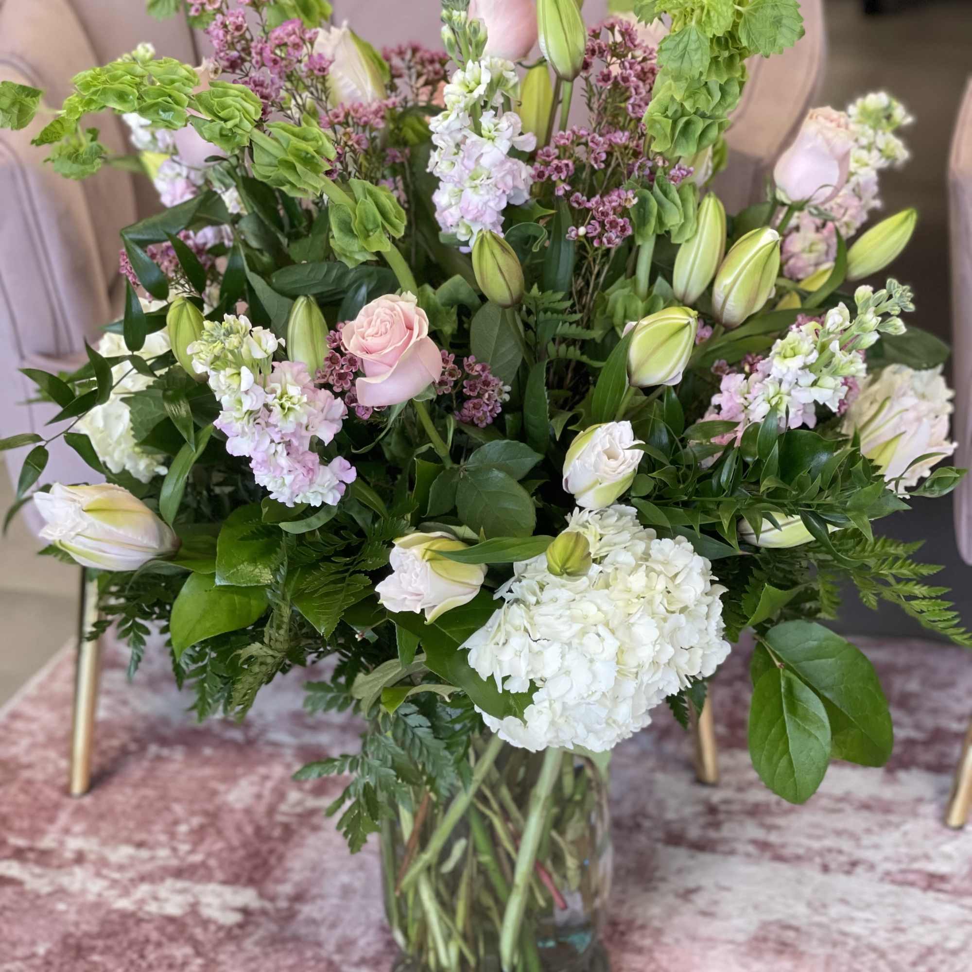 Mixed bouquet of pink and white flowers in a glass vase