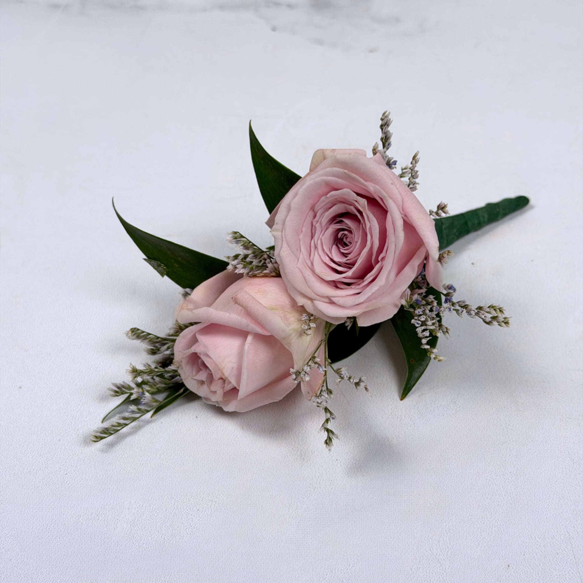 Soft pale lavender roses take center stage in this Amethyst boutonniere, a