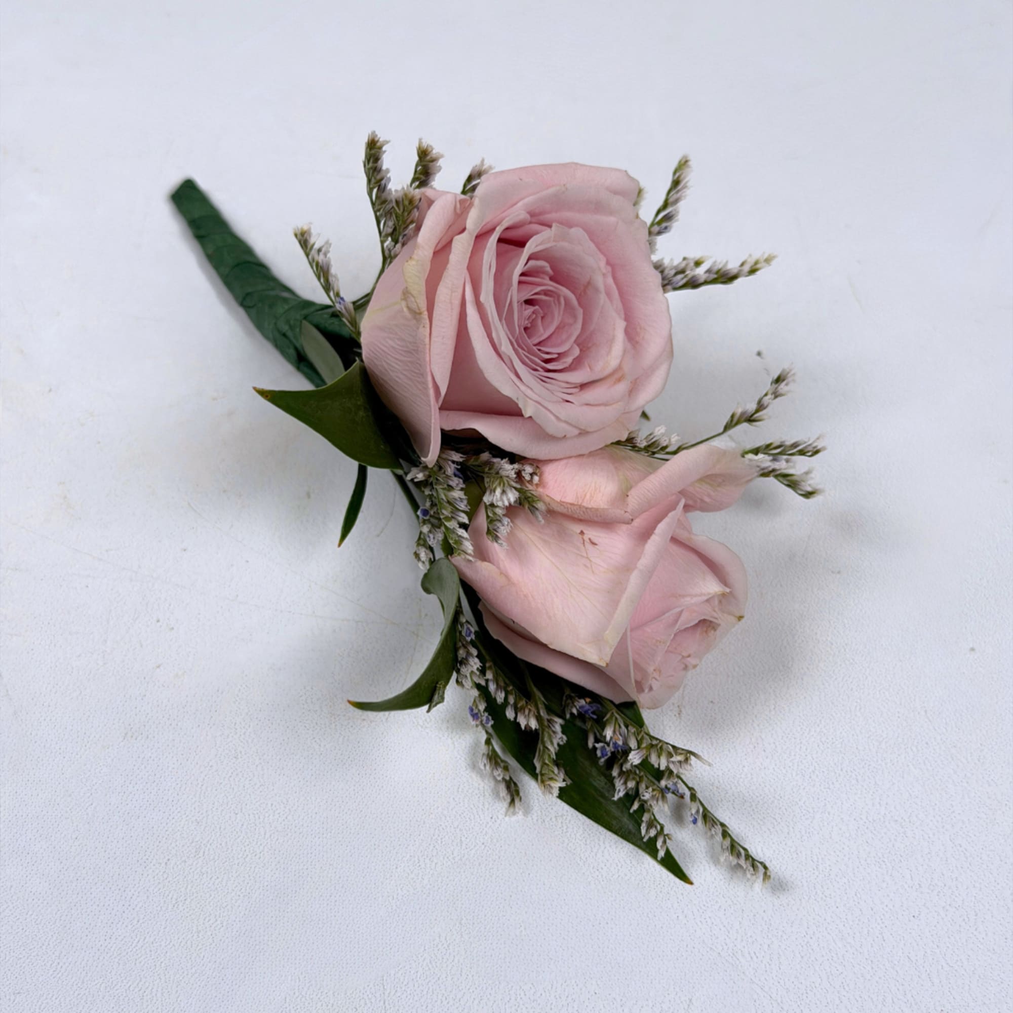 Soft pale lavender roses take center stage in this Amethyst boutonniere, a