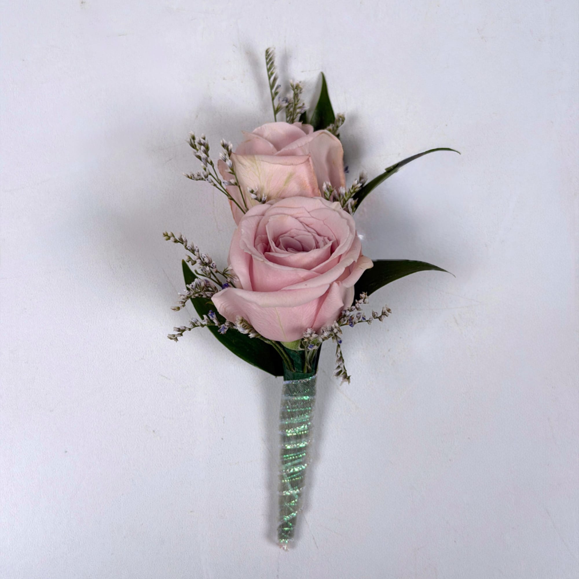 Soft pale lavender roses take center stage in this Amethyst boutonniere, a