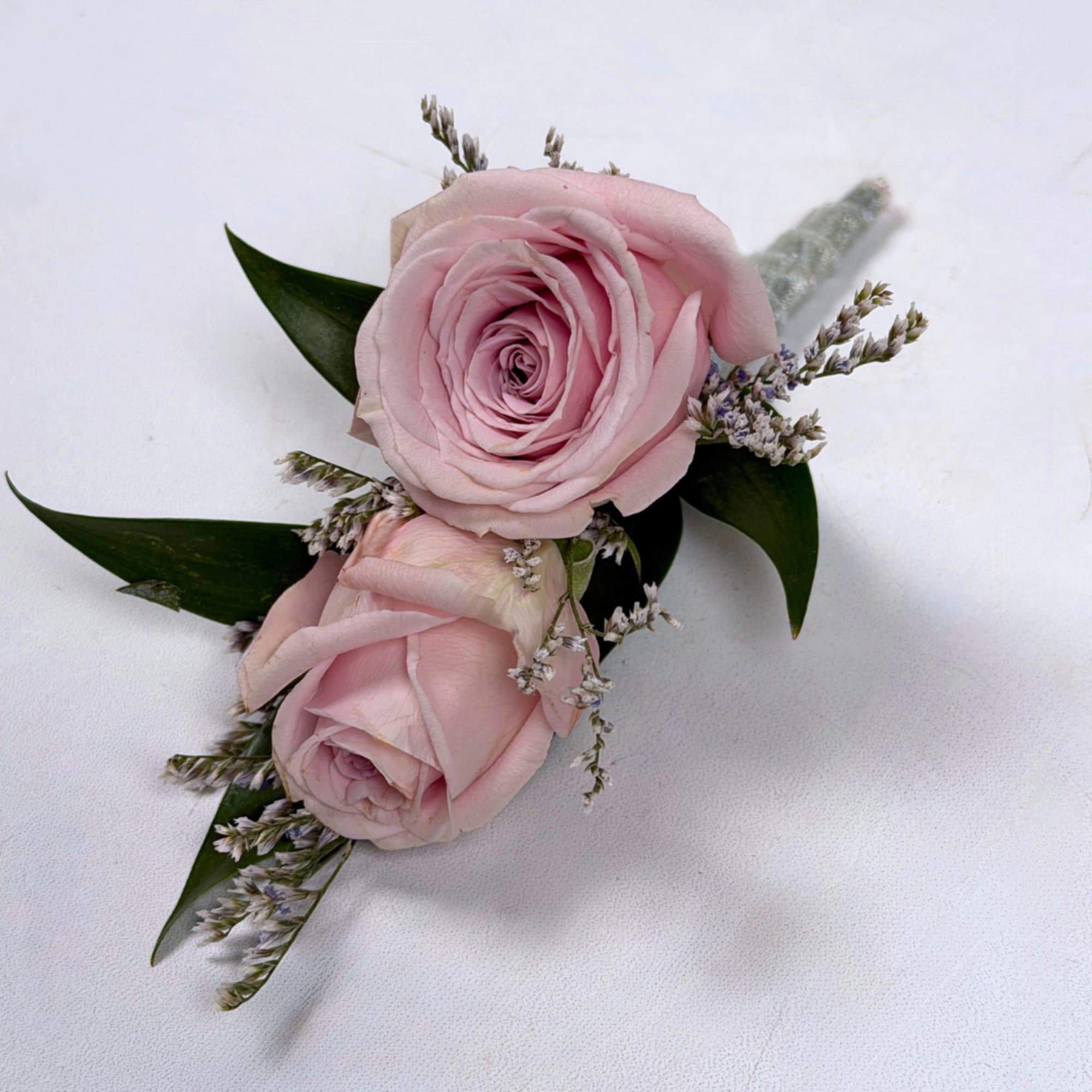 Soft pale lavender roses take center stage in this Amethyst boutonniere, a