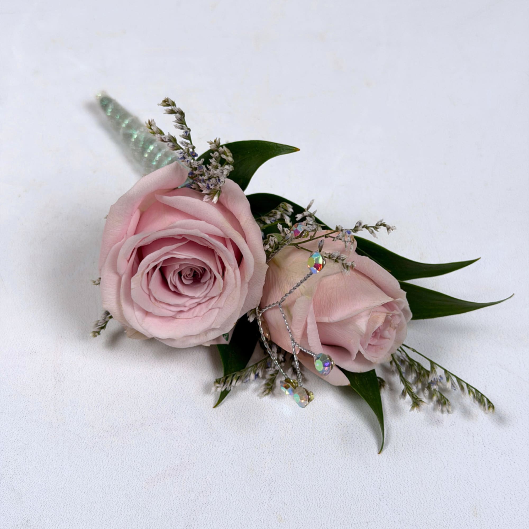 Soft pale lavender roses take center stage in this Amethyst boutonniere, a