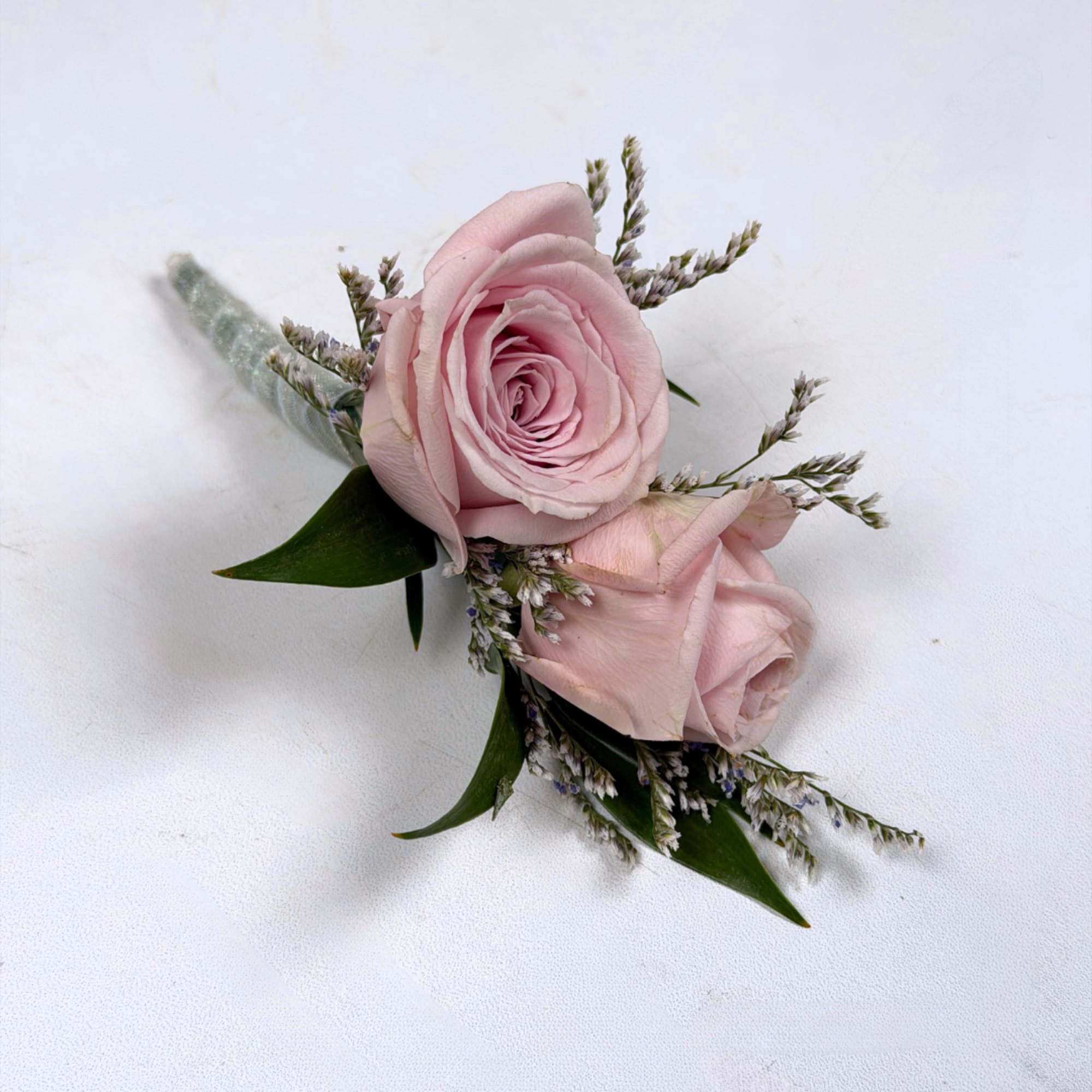 Soft pale lavender roses take center stage in this Amethyst boutonniere, a