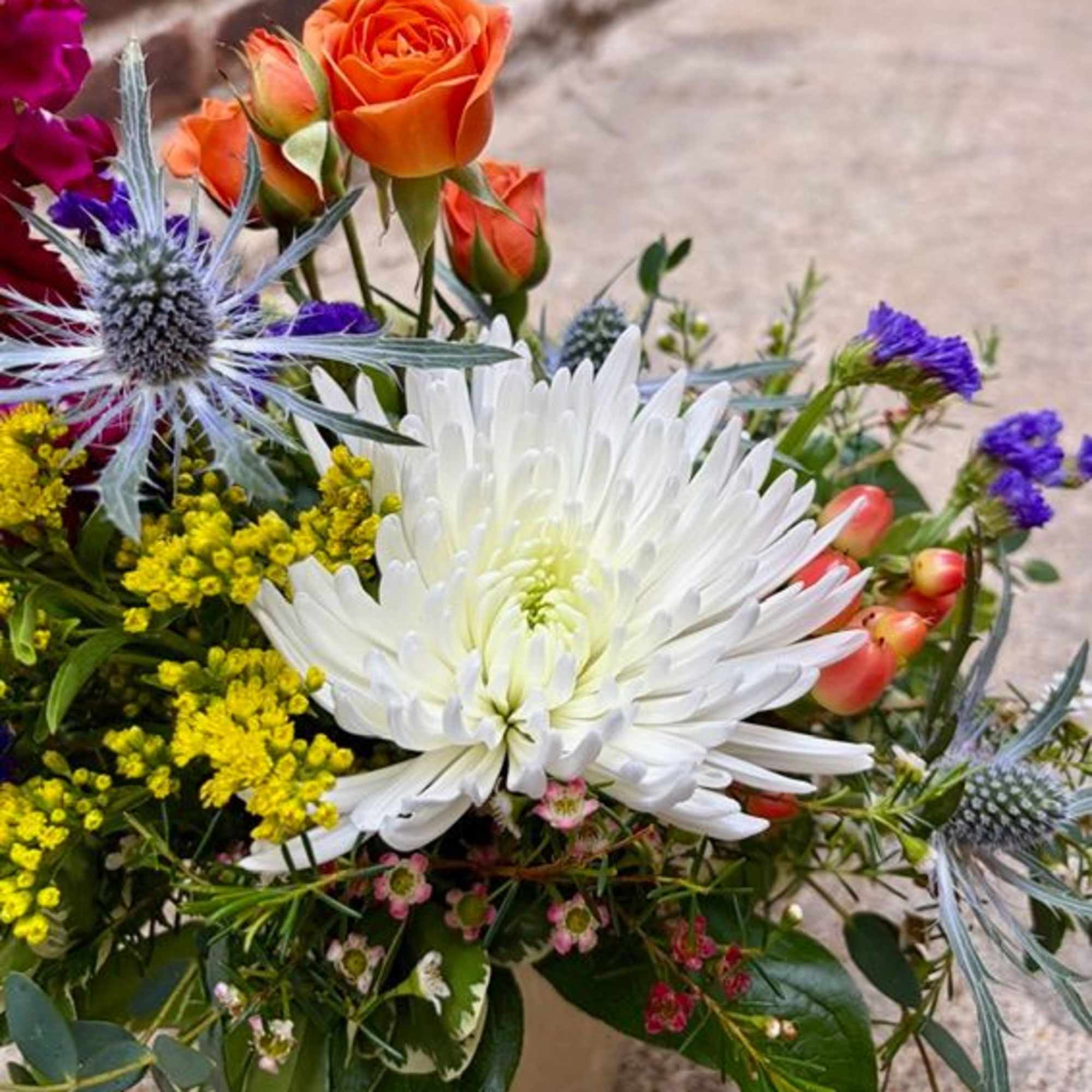 "Brilliant Blossoms" is a beautiful and petite floral design of vibrant flowers