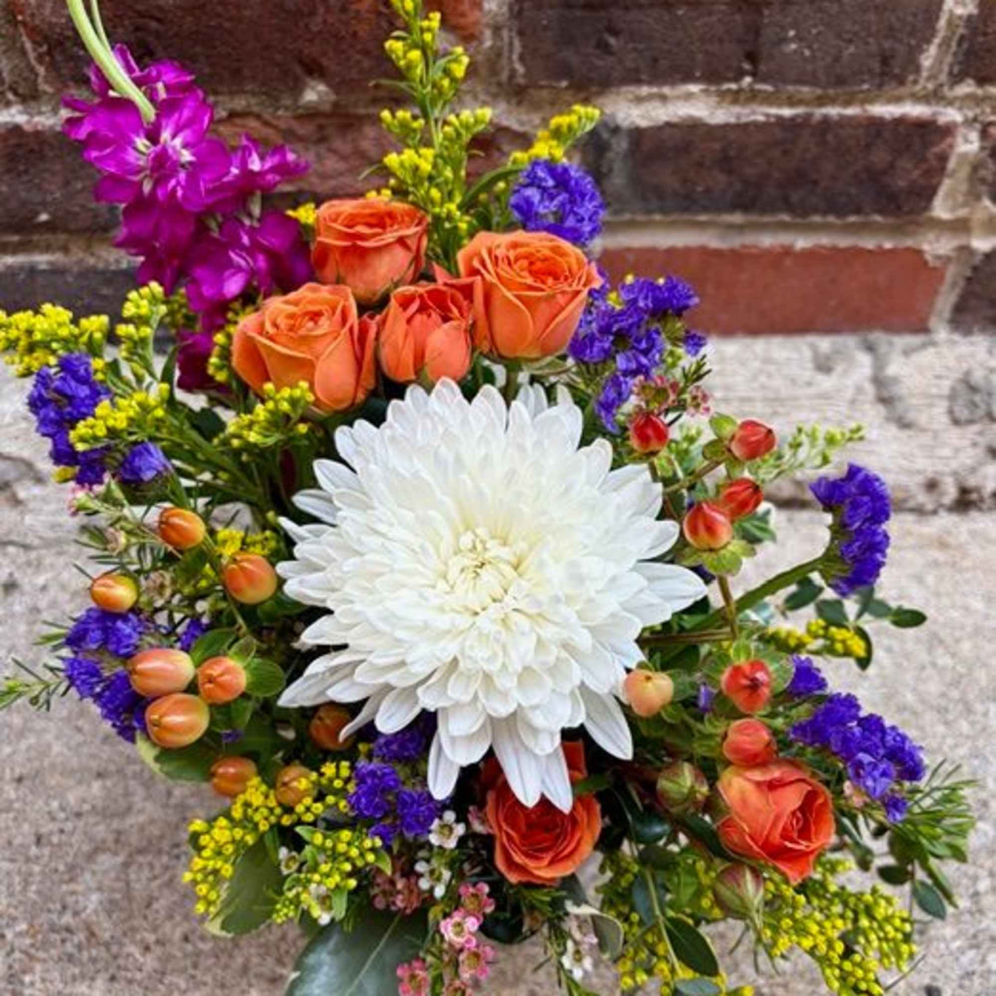 "Brilliant Blossoms" is a beautiful and petite floral design of vibrant flowers