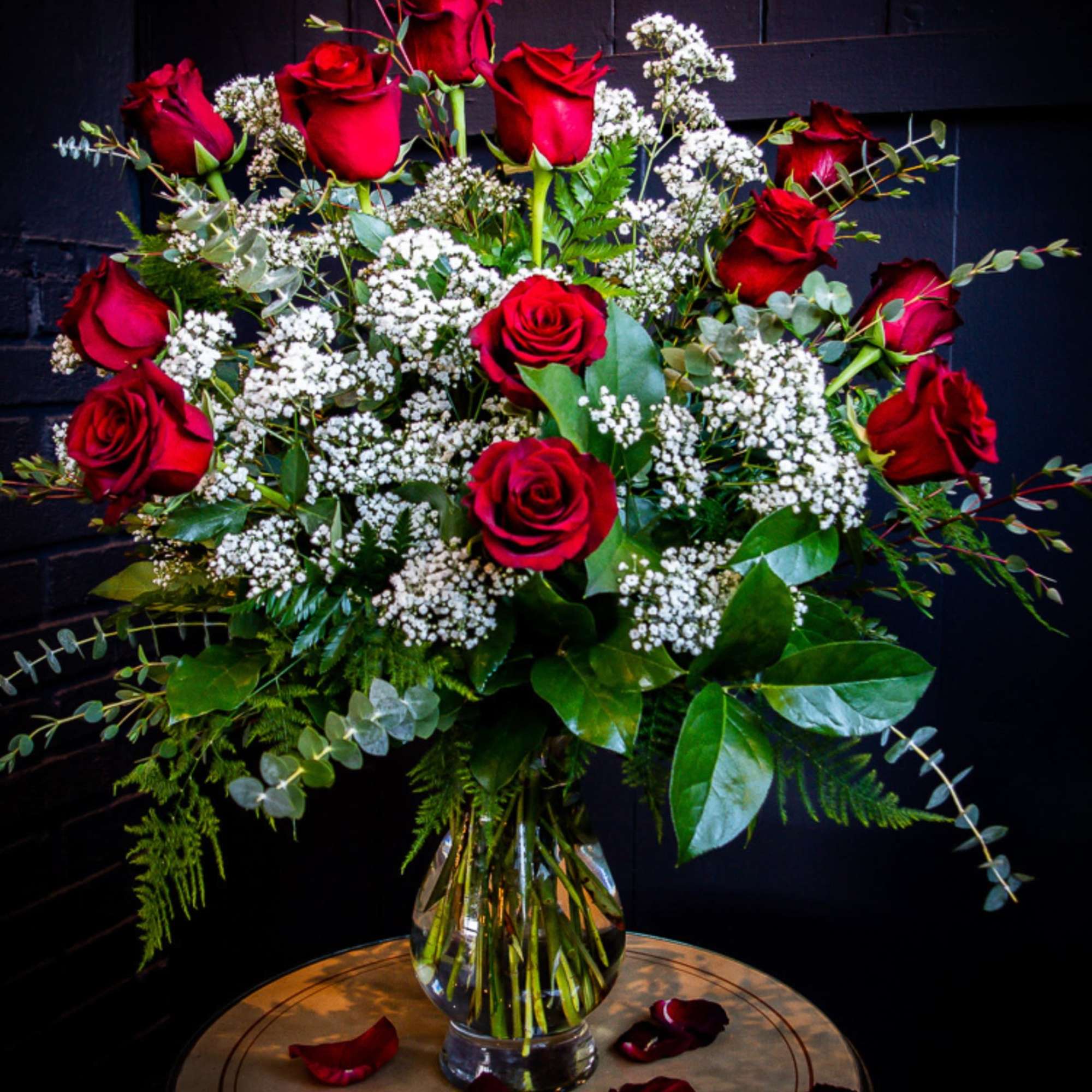 Red roses and white baby's breath in a glass vase