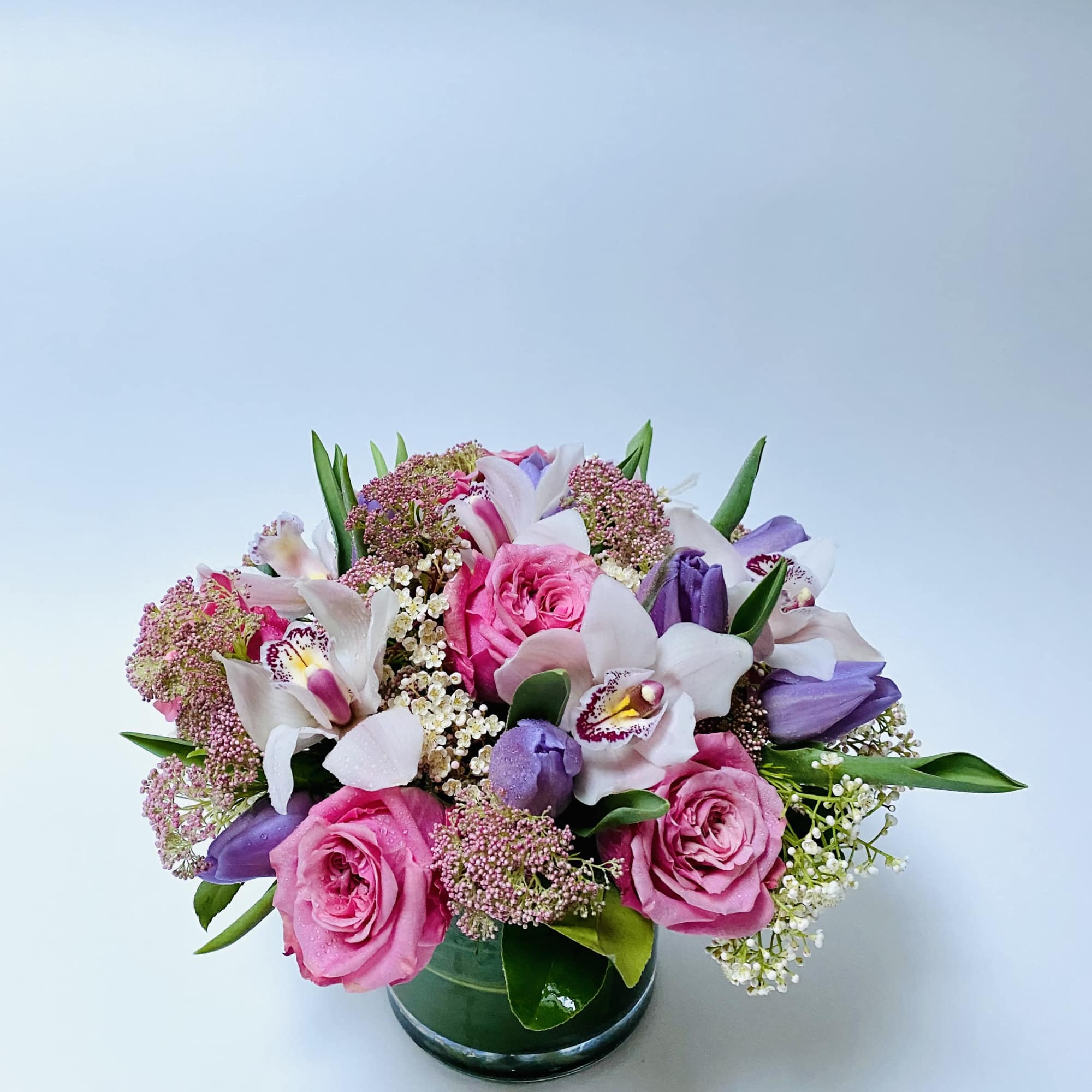A harmonious blend of soft pinks, lavender hues, and fresh greenery arranged