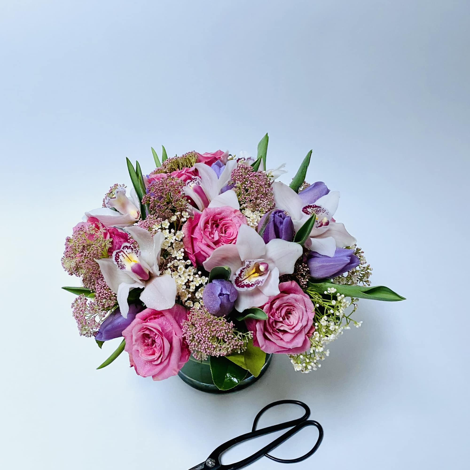 A harmonious blend of soft pinks, lavender hues, and fresh greenery arranged
