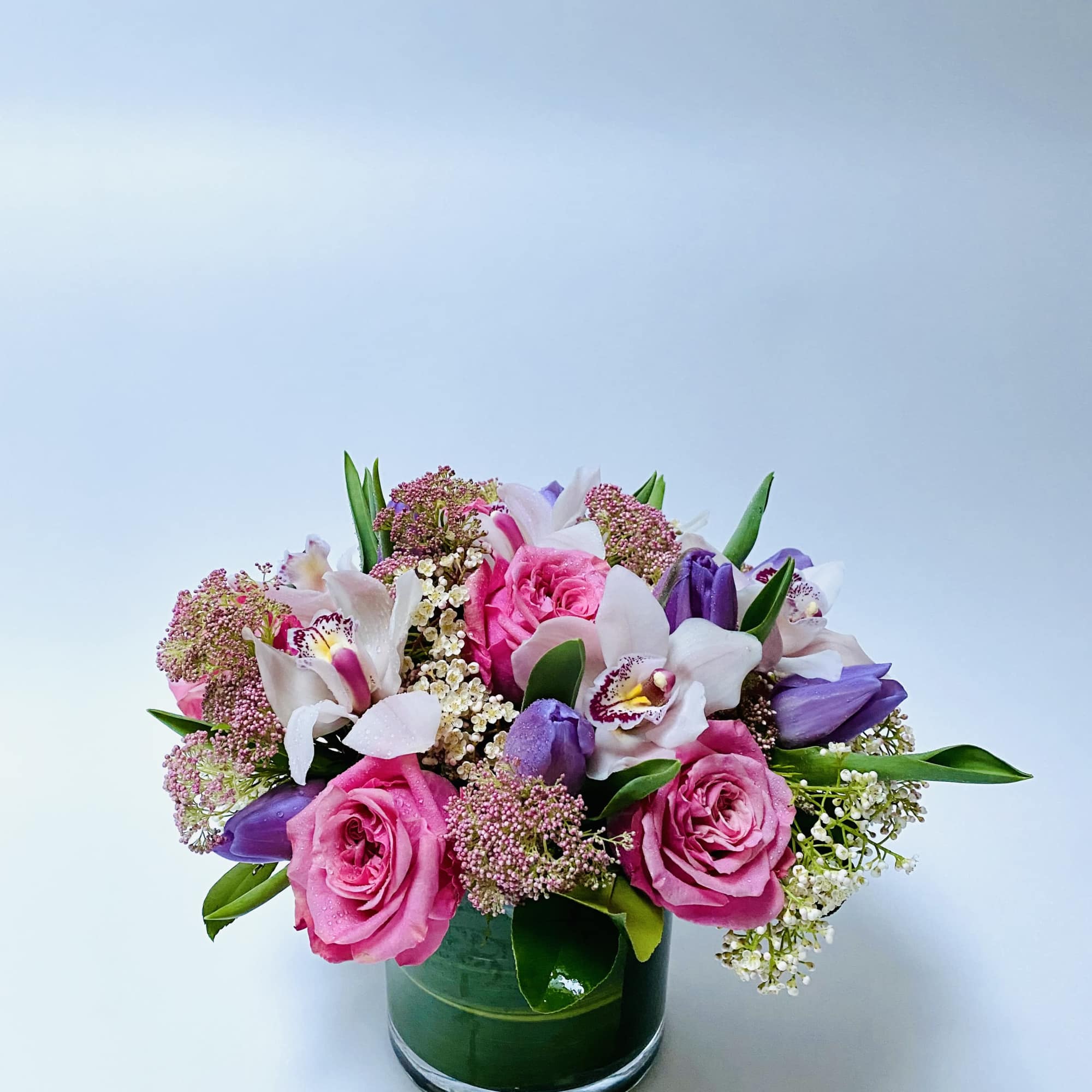 A harmonious blend of soft pinks, lavender hues, and fresh greenery arranged