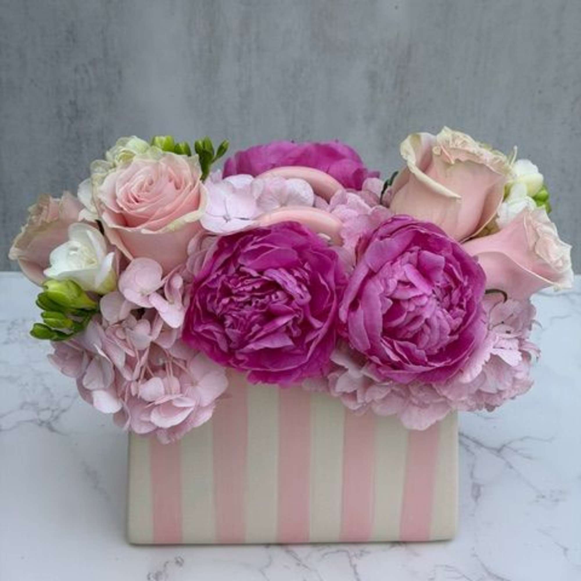 A beautiful ceramic pink and white stripped "pocketbook" measuring 5" x 8"