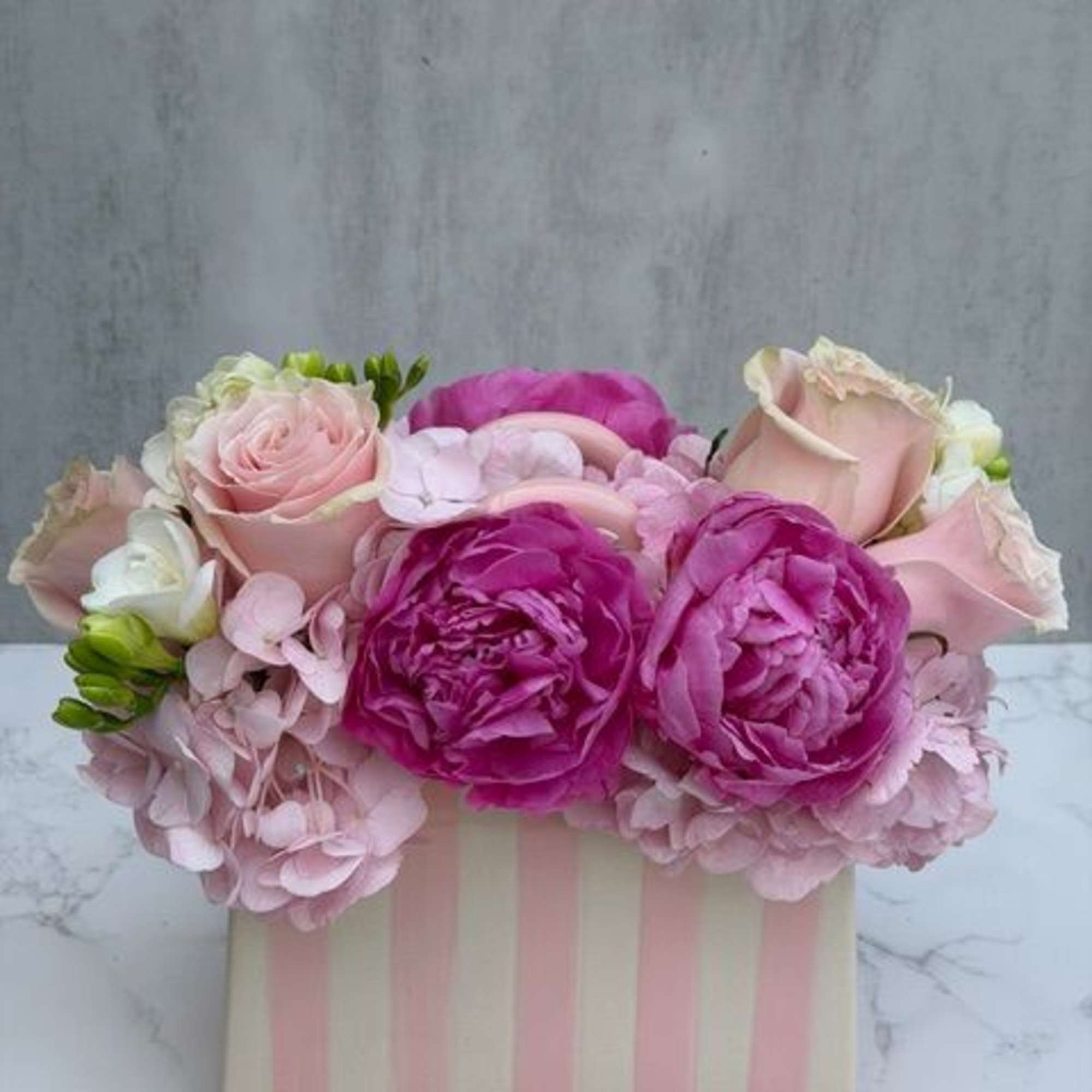 A beautiful ceramic pink and white stripped "pocketbook" measuring 5" x 8"