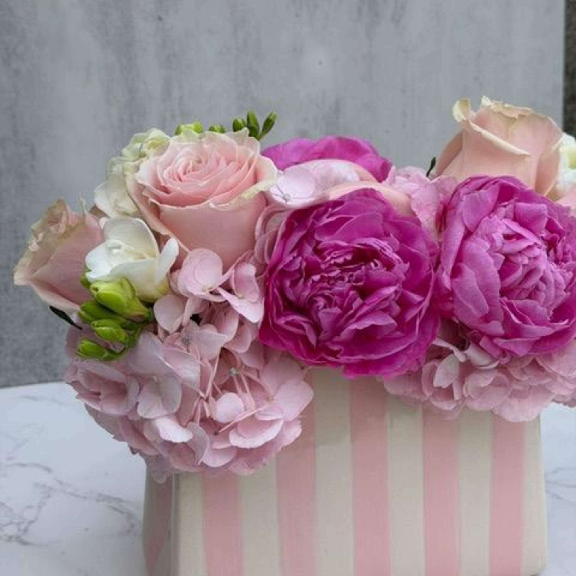 A beautiful ceramic pink and white stripped "pocketbook" measuring 5" x 8"