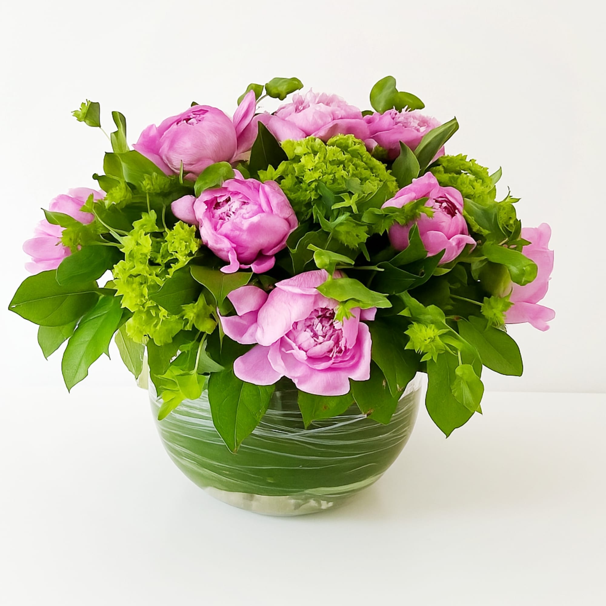 This arrangement is presented in a 8" clear glass bowl. It includes