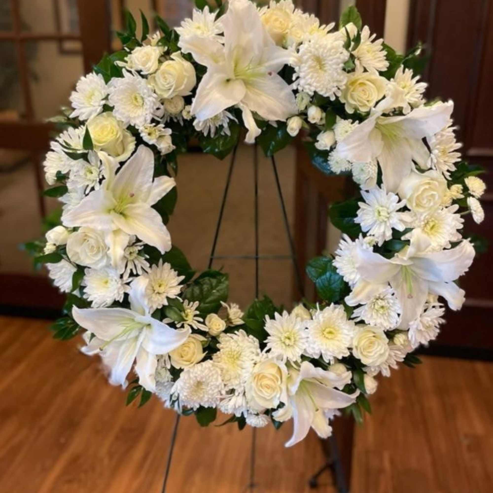 A serene circular sympathy wreath designed to offer calm and grace, this