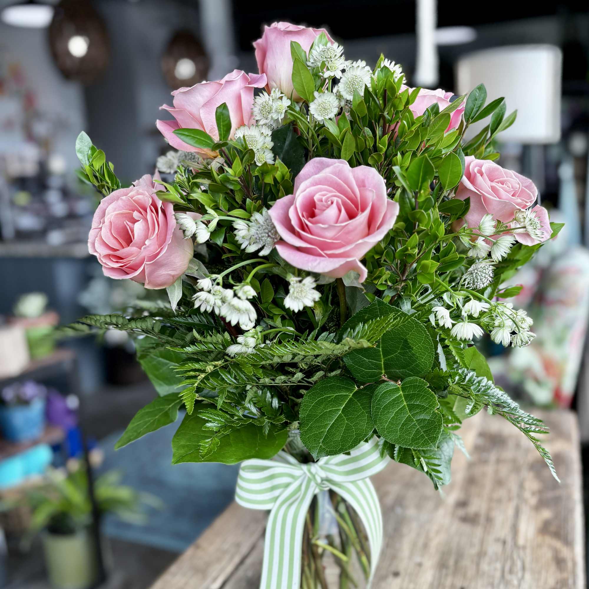 12 pink roses designed in a traditional style.
