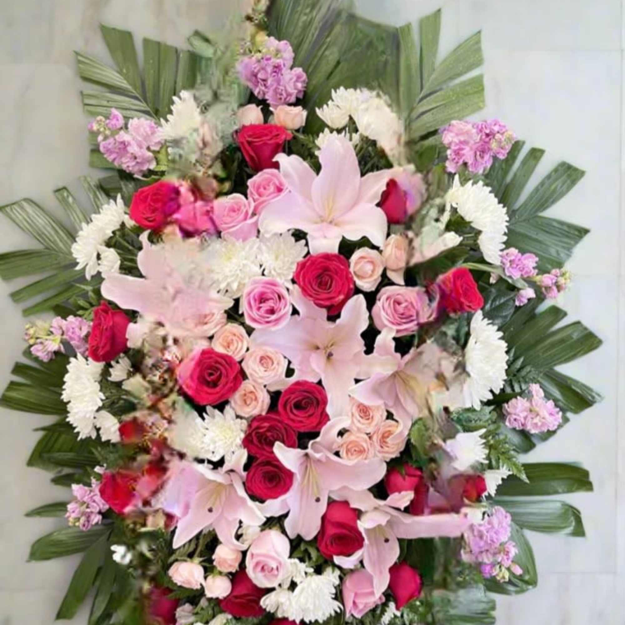 A lush standing wreath for sympathy and memorial services, this large floral