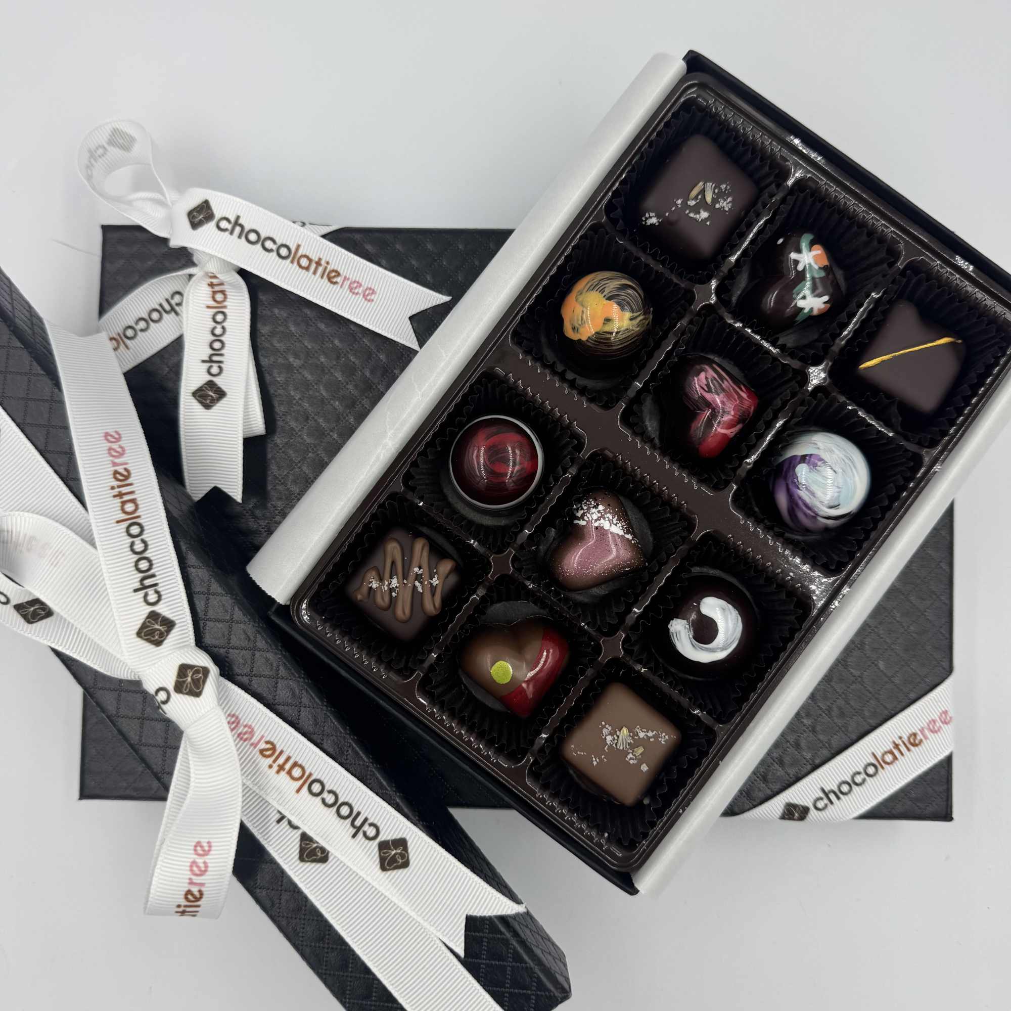 Box of assorted chocolates with decorative ribbons
