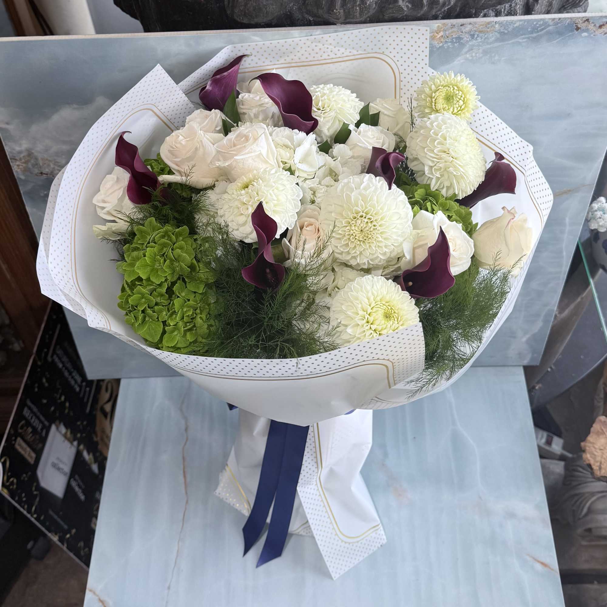 Where timeless whites meet rich, moody tones. This hand-wrapped bouquet blends soft