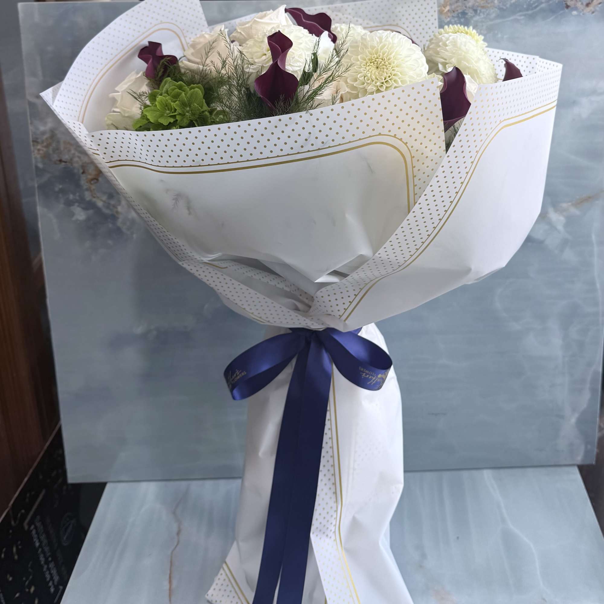 Where timeless whites meet rich, moody tones. This hand-wrapped bouquet blends soft