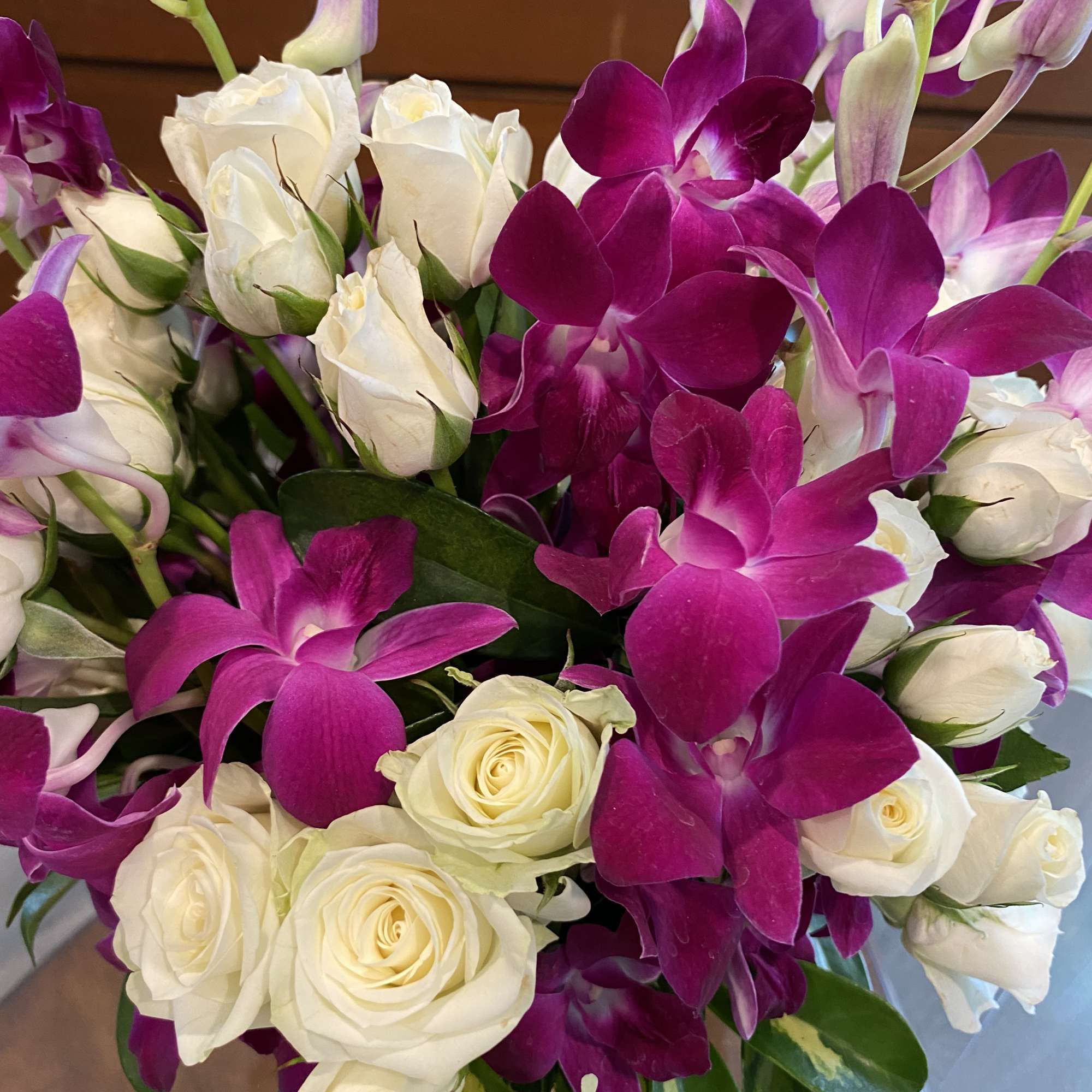 Bouquet of white roses and magenta orchids