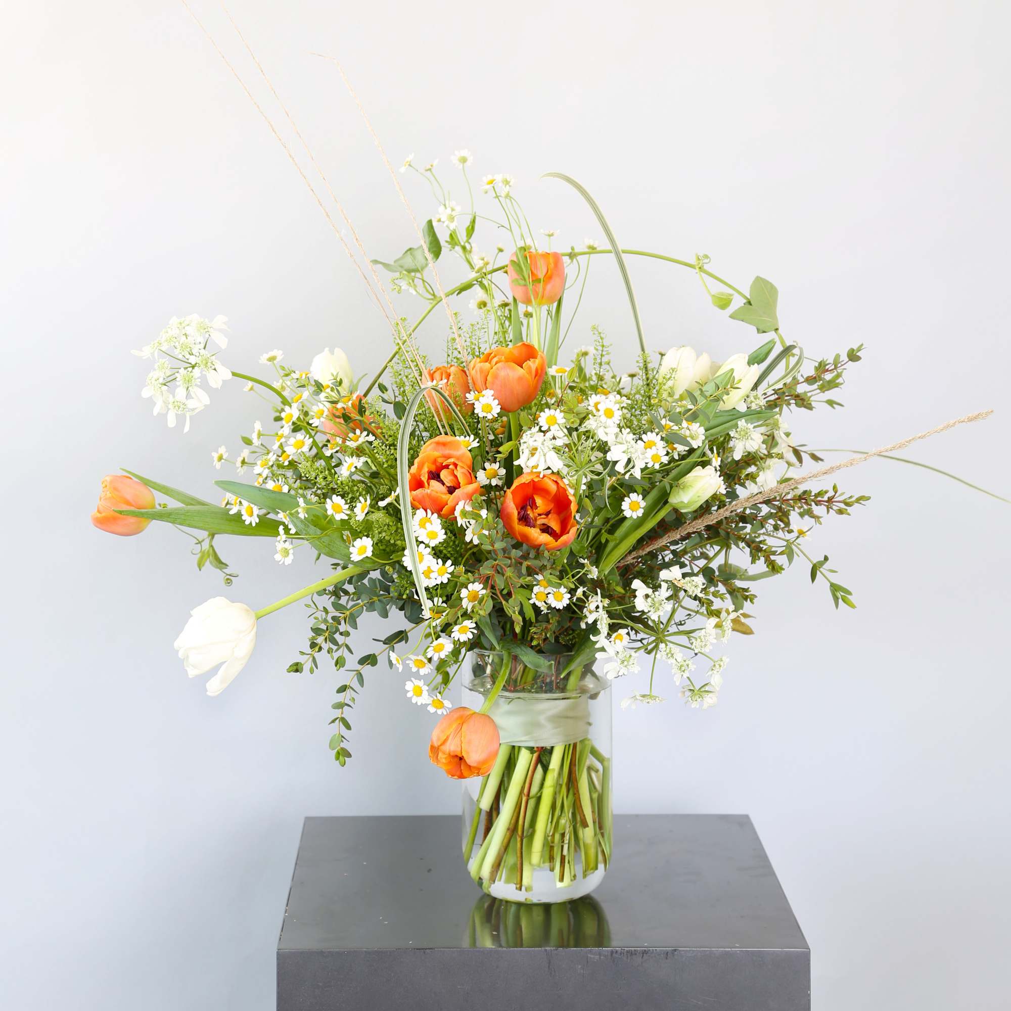 An adorable wild flower style bouquet create by Orange and Ivory tulip