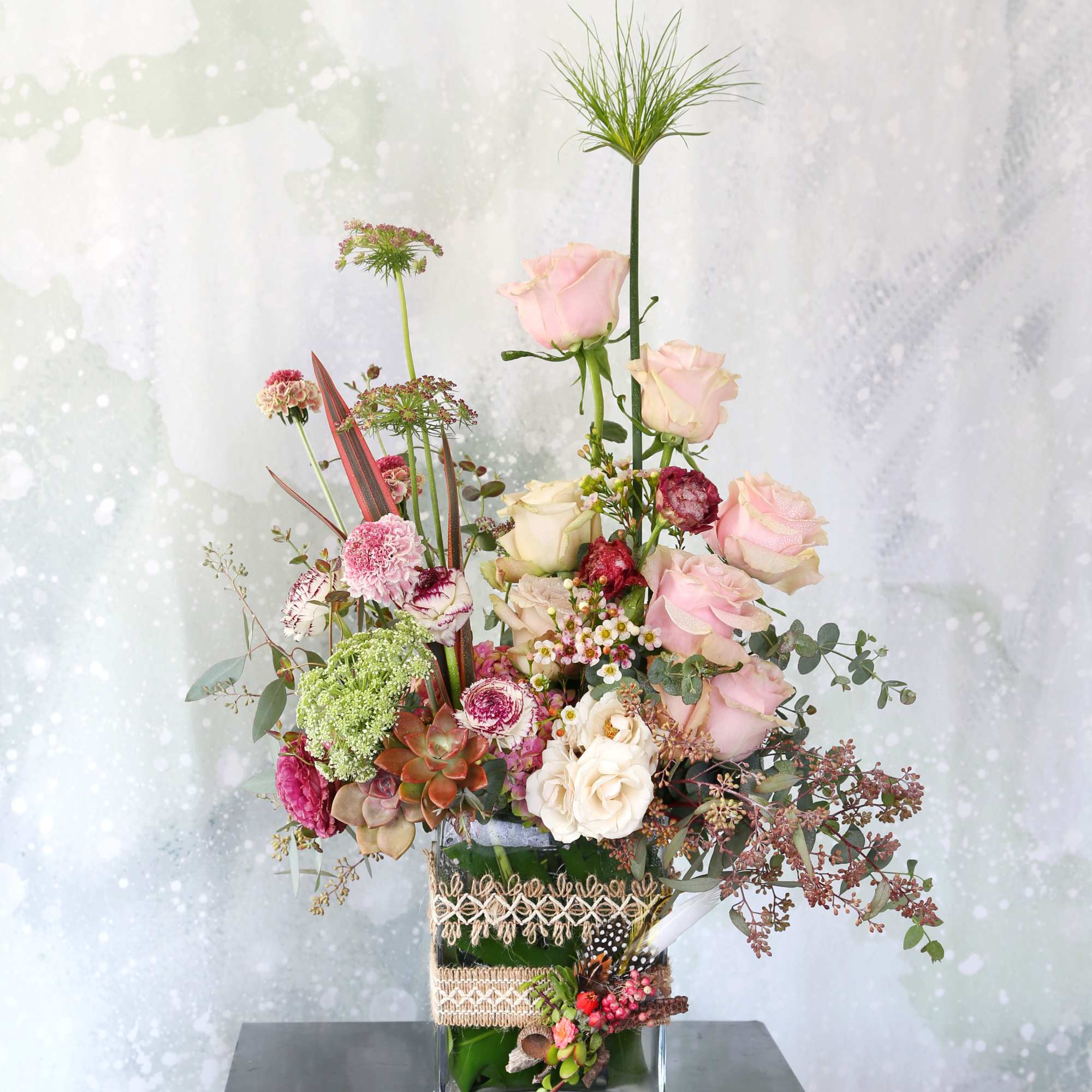 This arrangement made with a dozen different shade blush to ivory garden