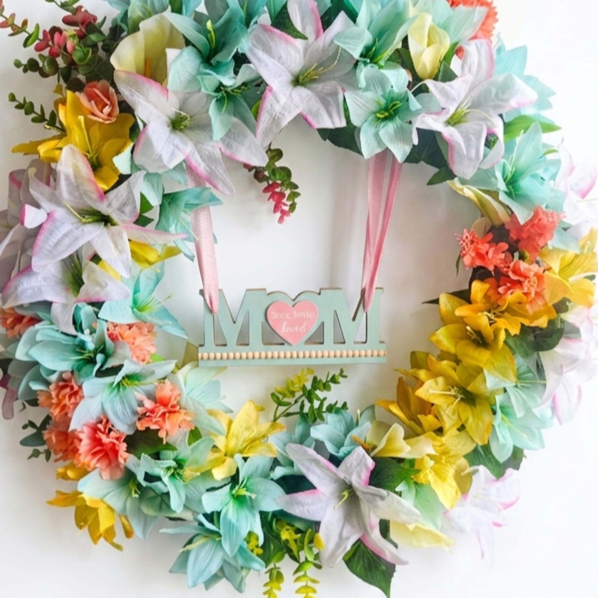 Pastel lilies in soft aqua, pink, white and sunny yellow give this