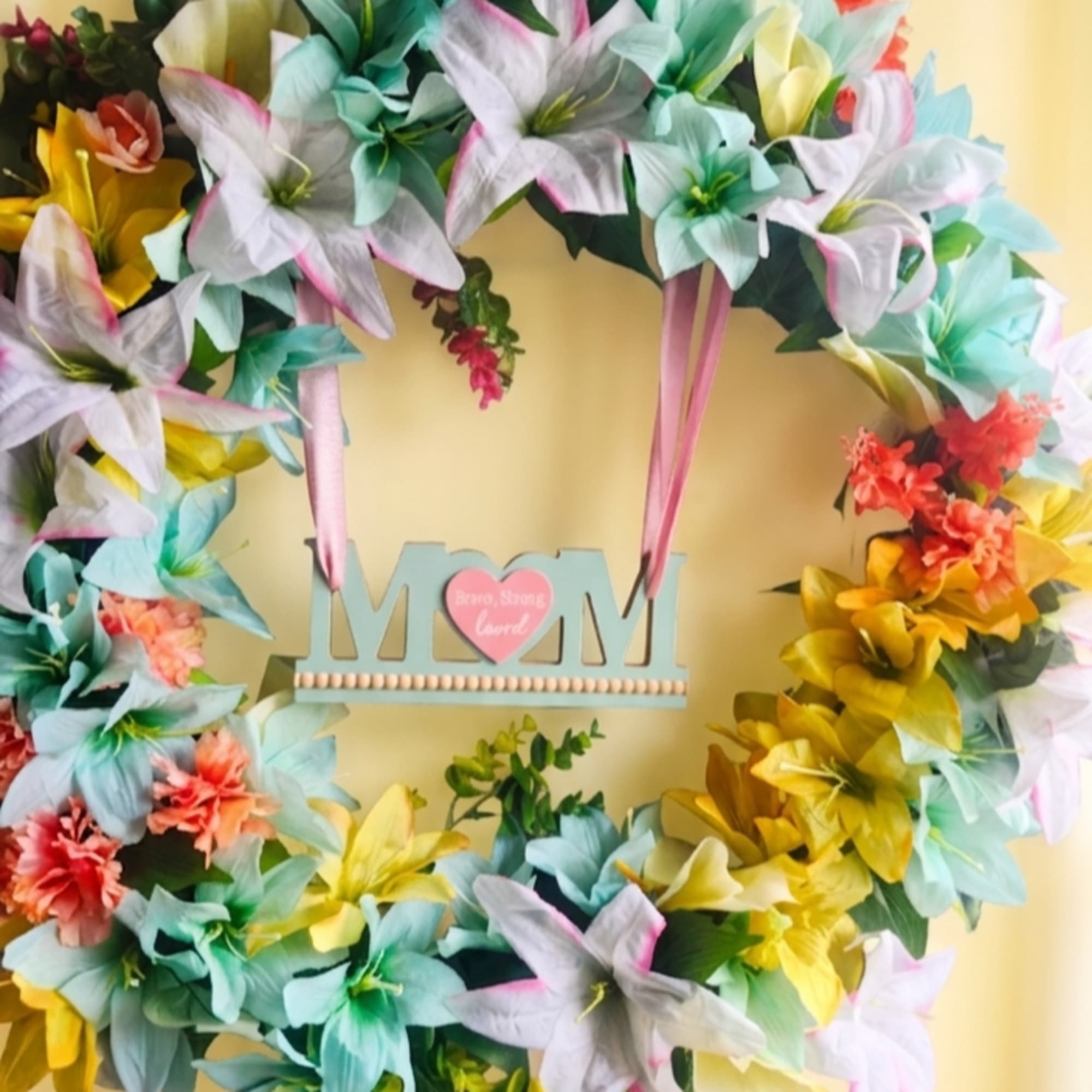 Pastel lilies in soft aqua, pink, white and sunny yellow give this