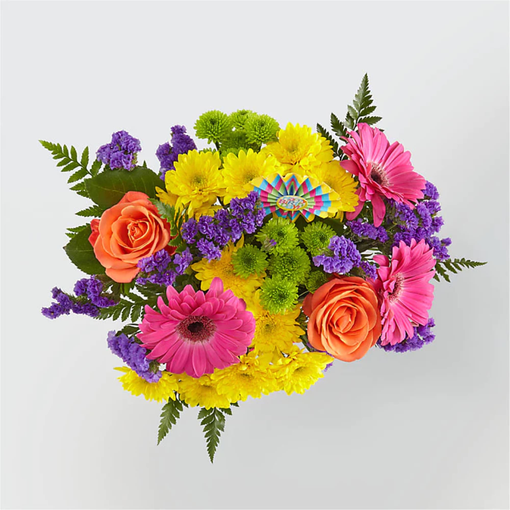 Bright mixed bouquet with pink gerbera daisies, orange roses, yellow and green mums, and purple filler flowers.