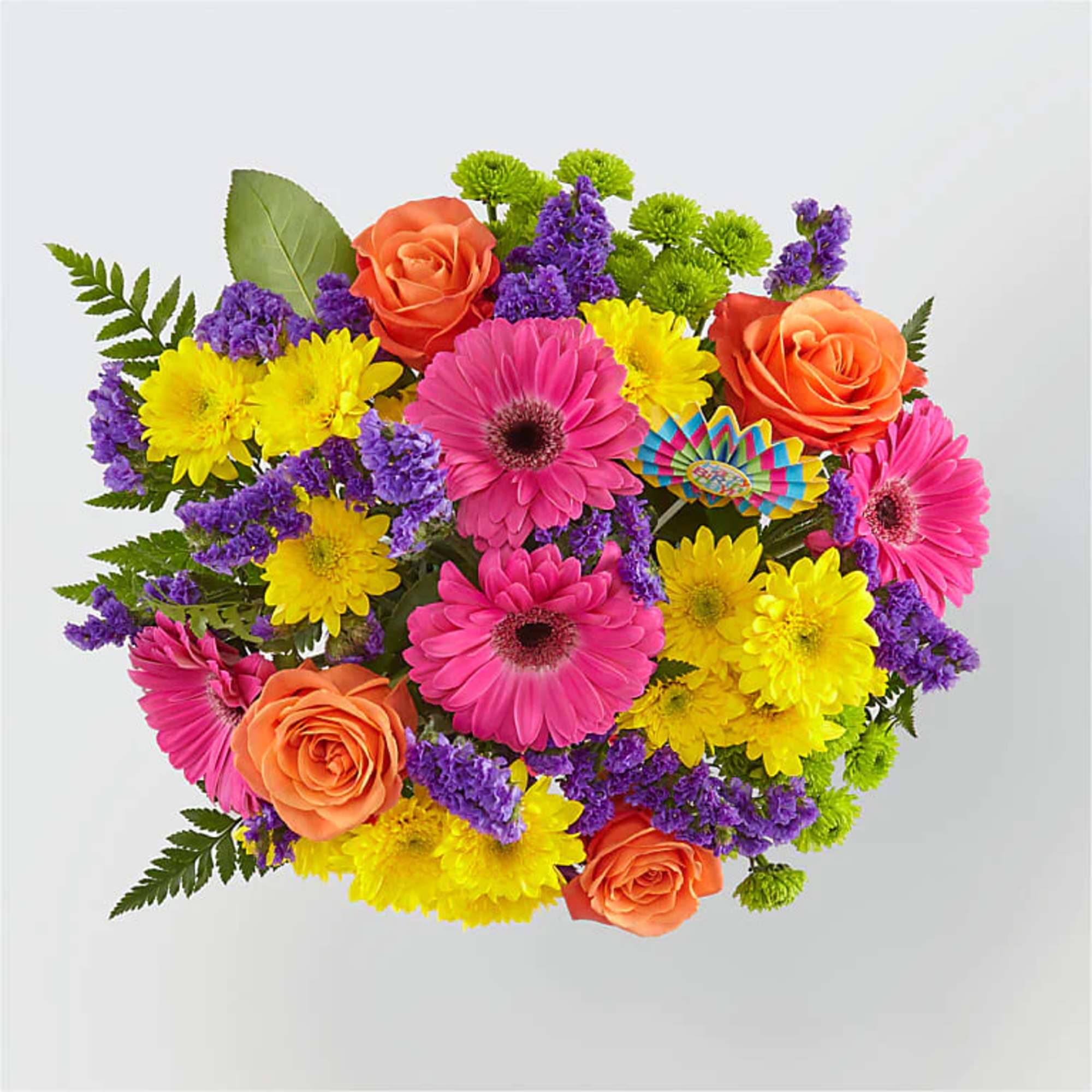 Bouquet of bright pink gerbera daisies, orange roses, yellow mums, and purple filler flowers with a colorful pick