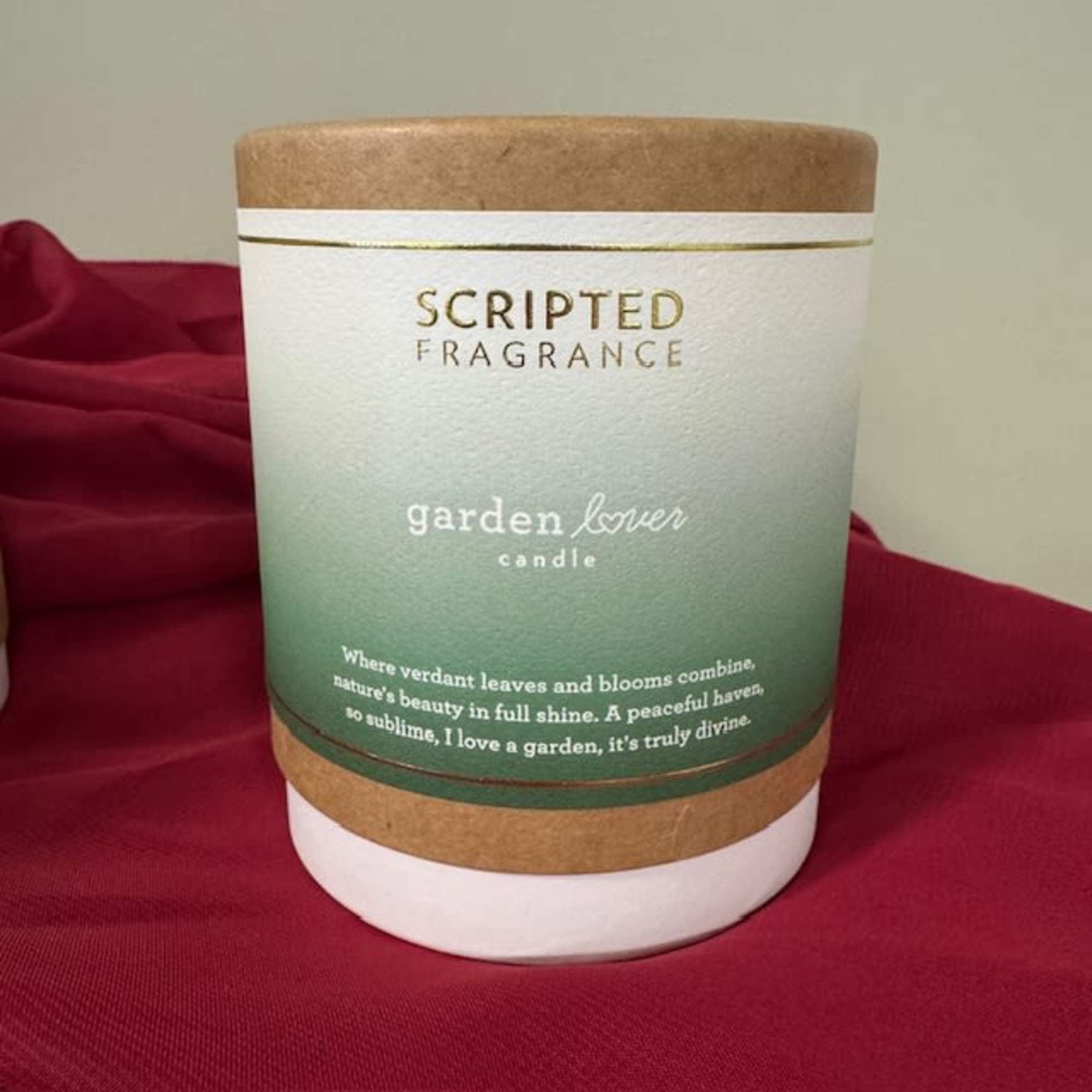 Scented candle in a cylindrical container with a green label