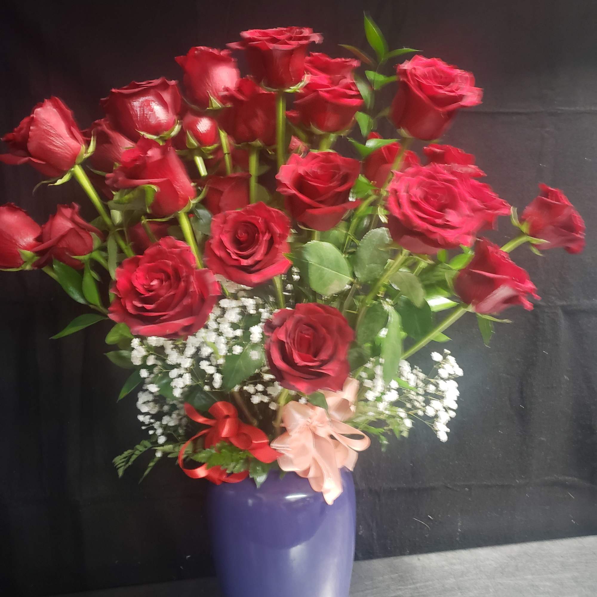 A lush dome of deep red roses takes center stage in this