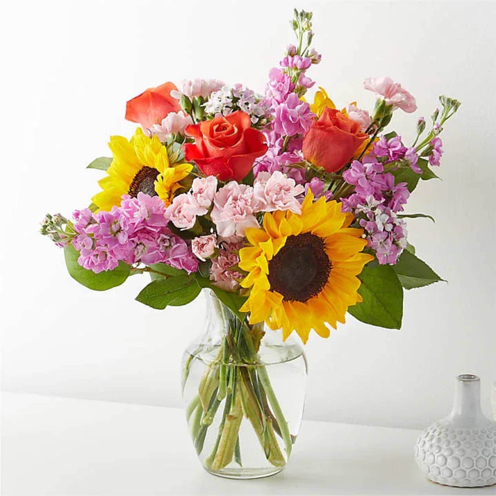 An eye-catching and cheerful arrangement designed to brighten any space. This vibrant